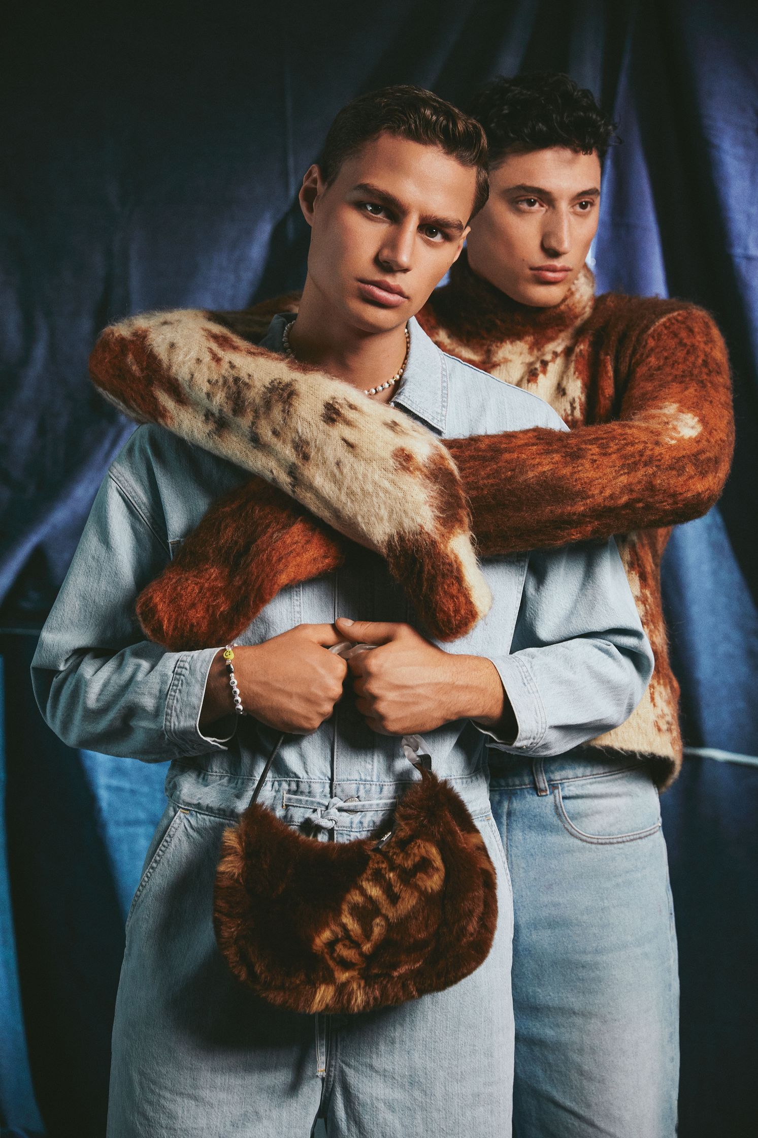 two men are posing for a fashion photoshoot