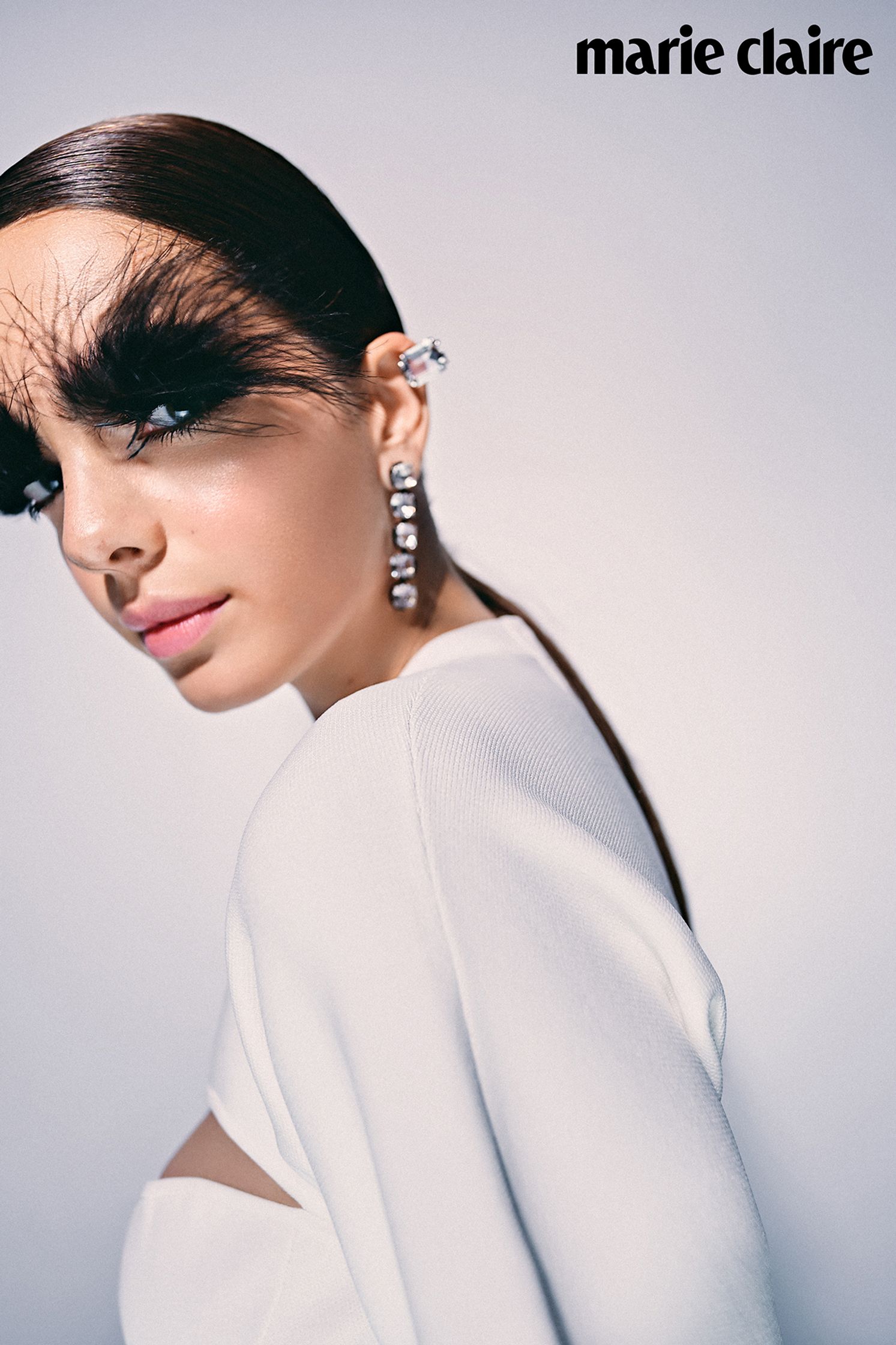 marie claire - a woman with feathers on her face