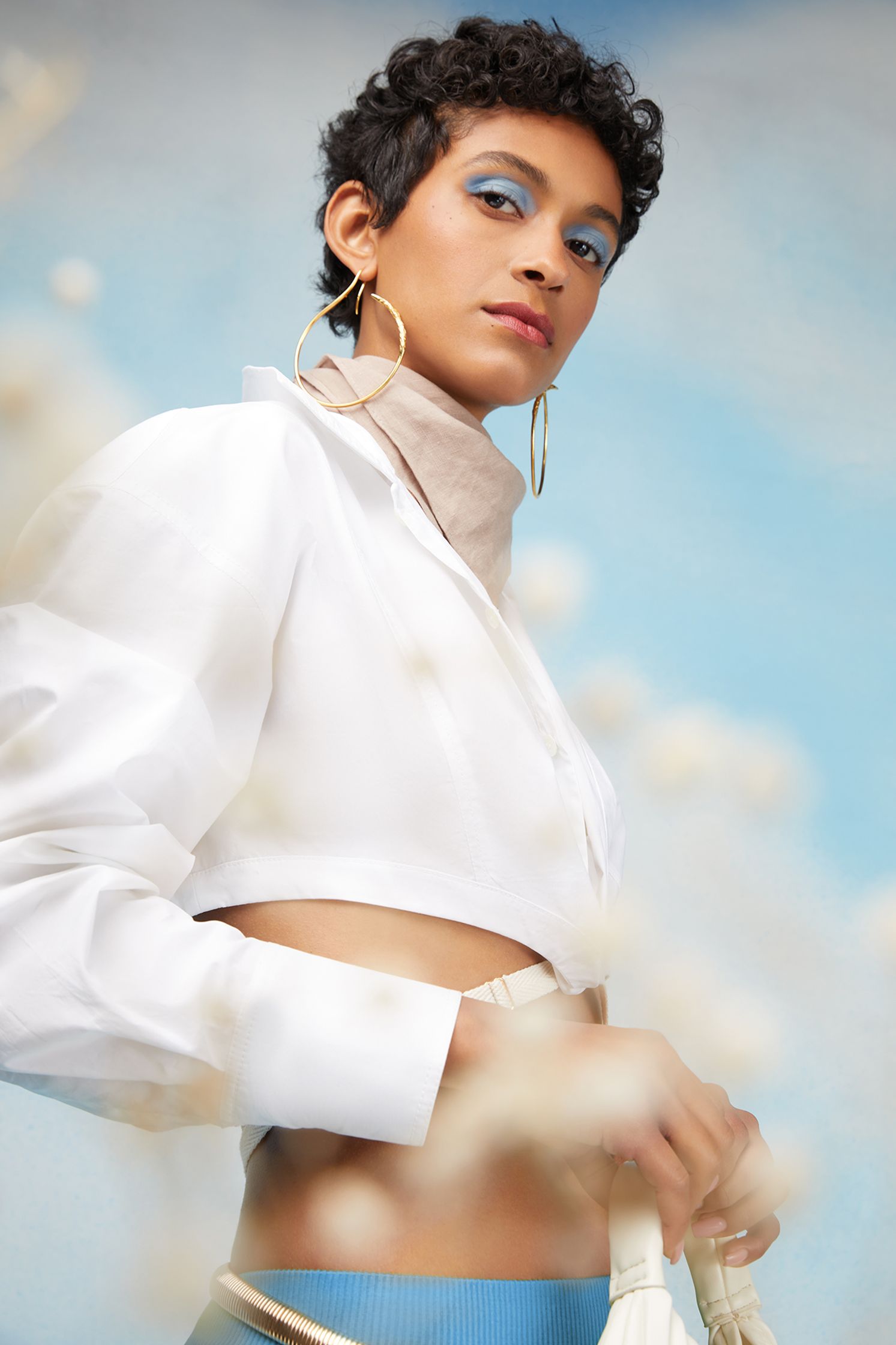 a woman wearing a white shirt and blue skirt