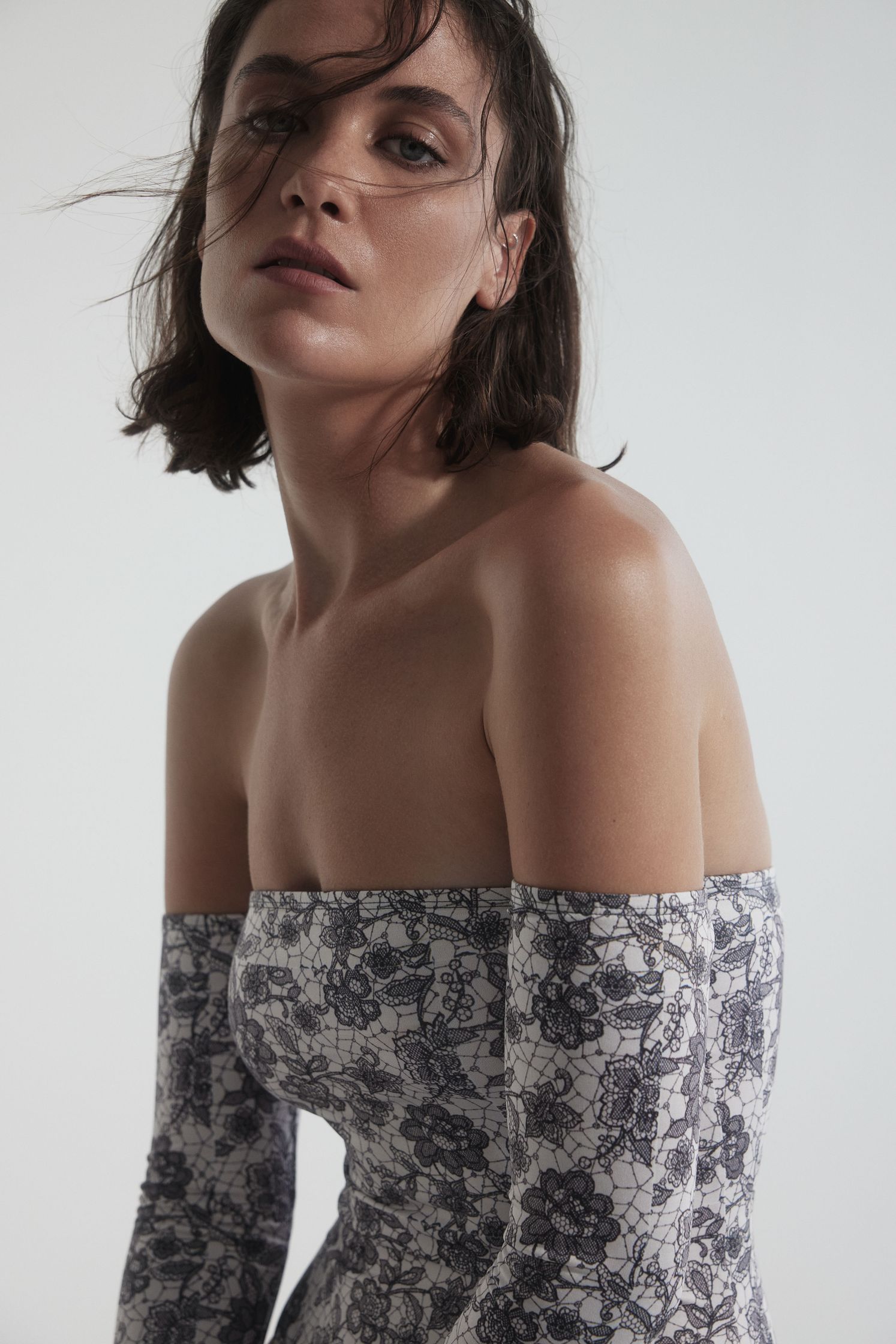 a woman in a floral dress posing for a photo