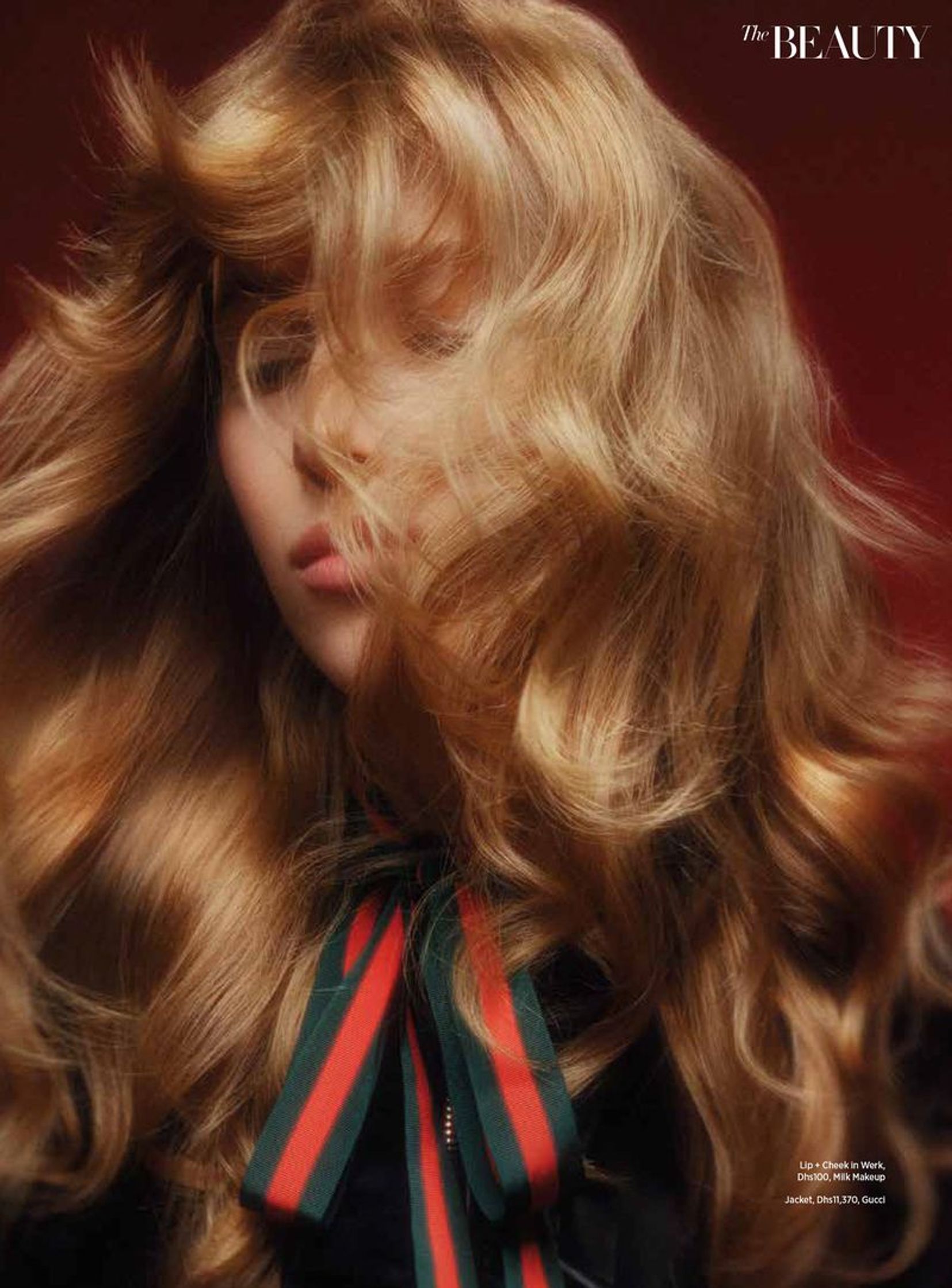 a woman with long hair blowing in the wind on the cover of the beauty magazine