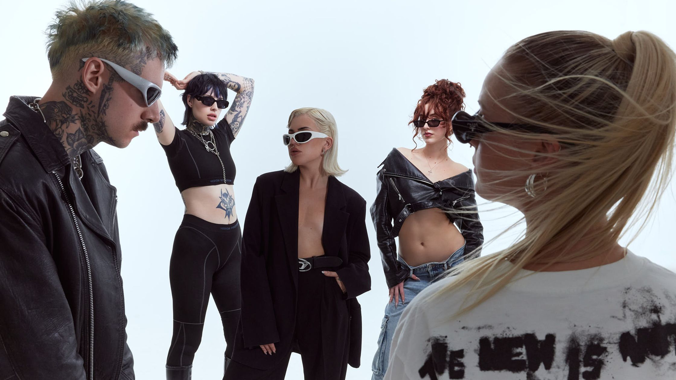 a group of people standing in front of a white background