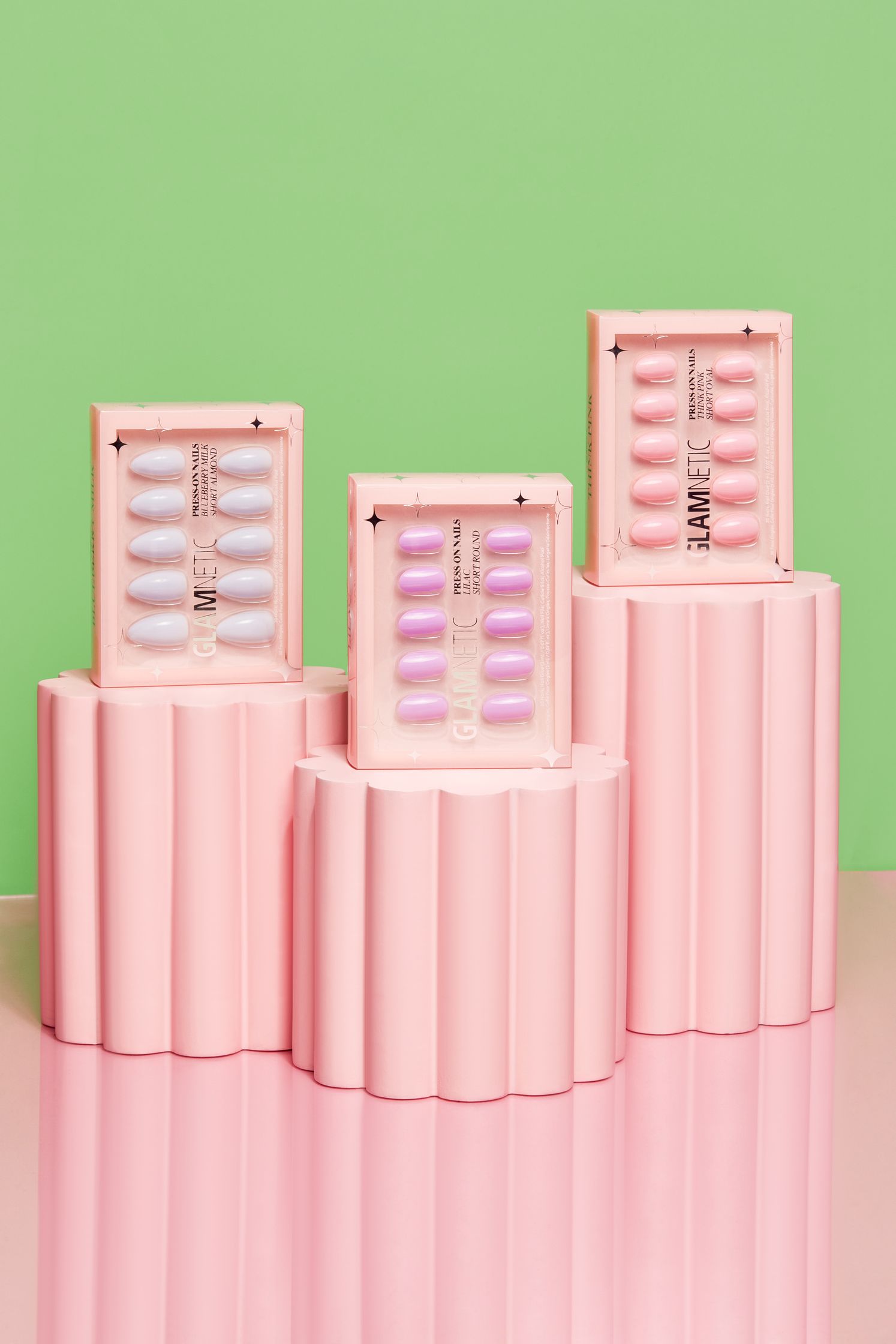 three pink boxes sitting on top of a pink background