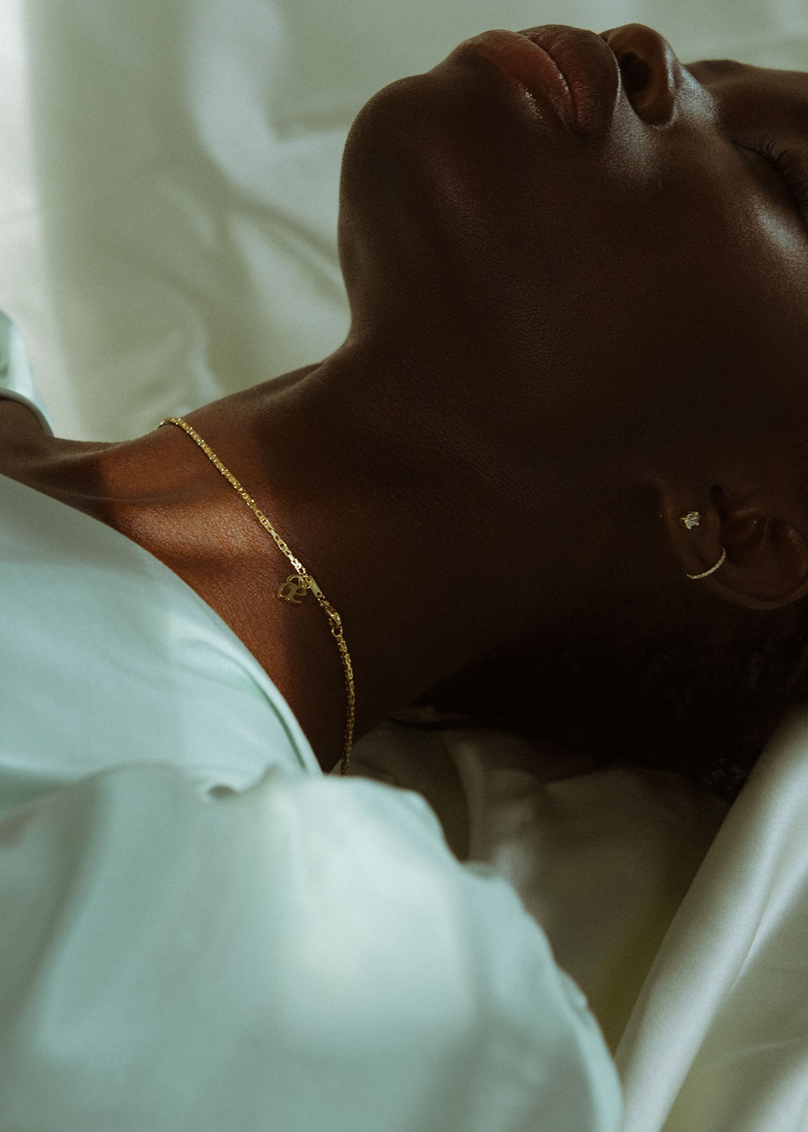 a woman laying in bed with her eyes closed