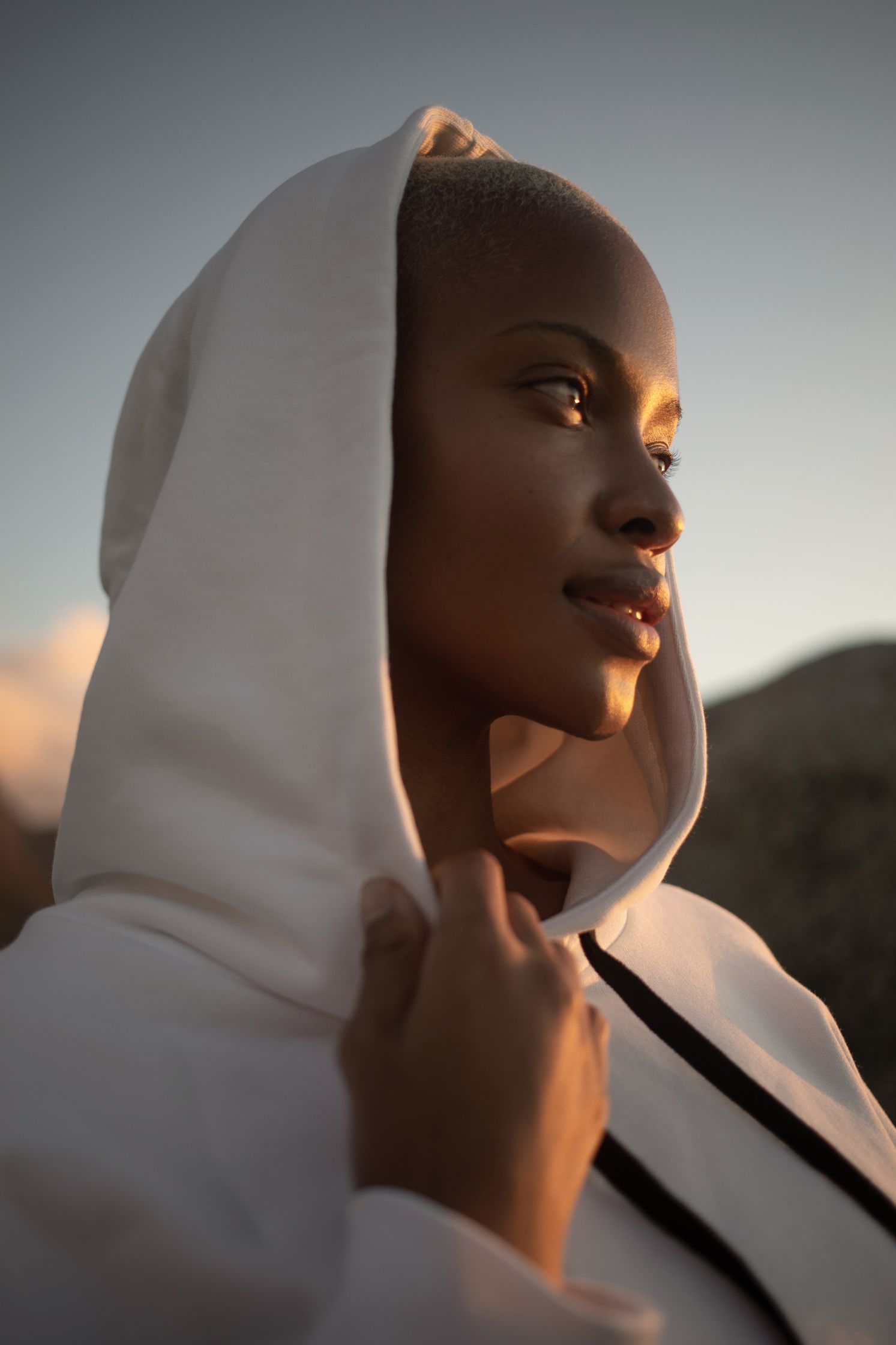 a black woman in a white hoodie