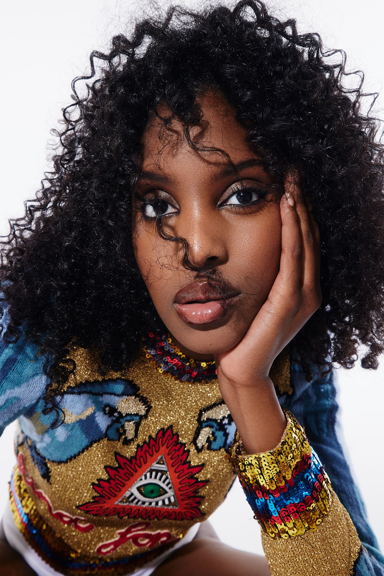 a woman with curly hair posing for a photo
