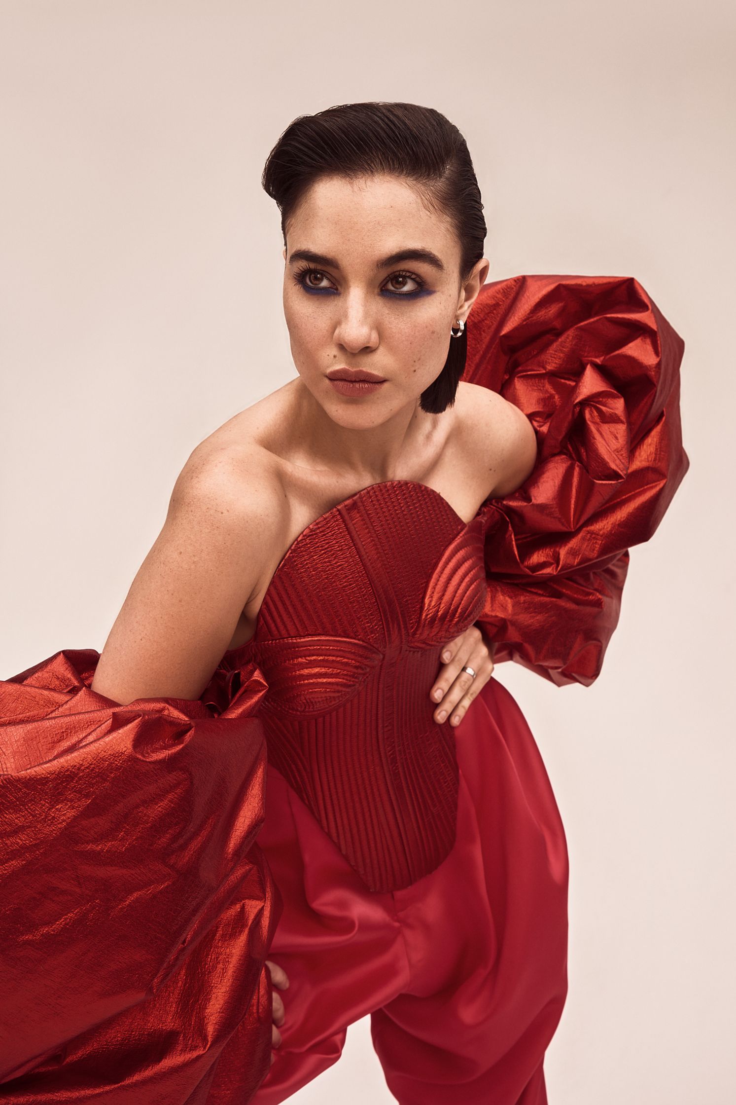 a woman in a red dress posing on a white background
