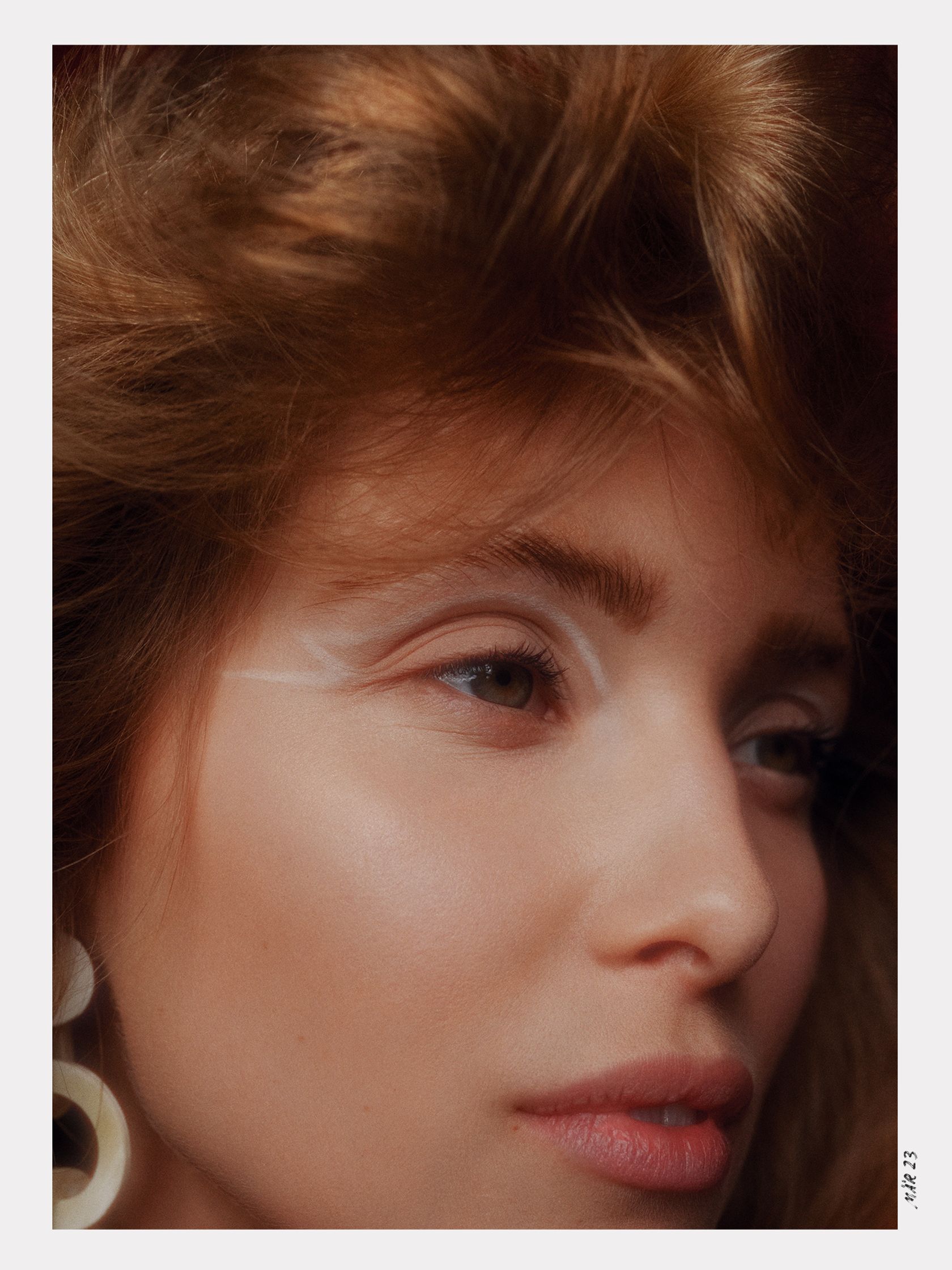 an image of a woman with long hair and earrings