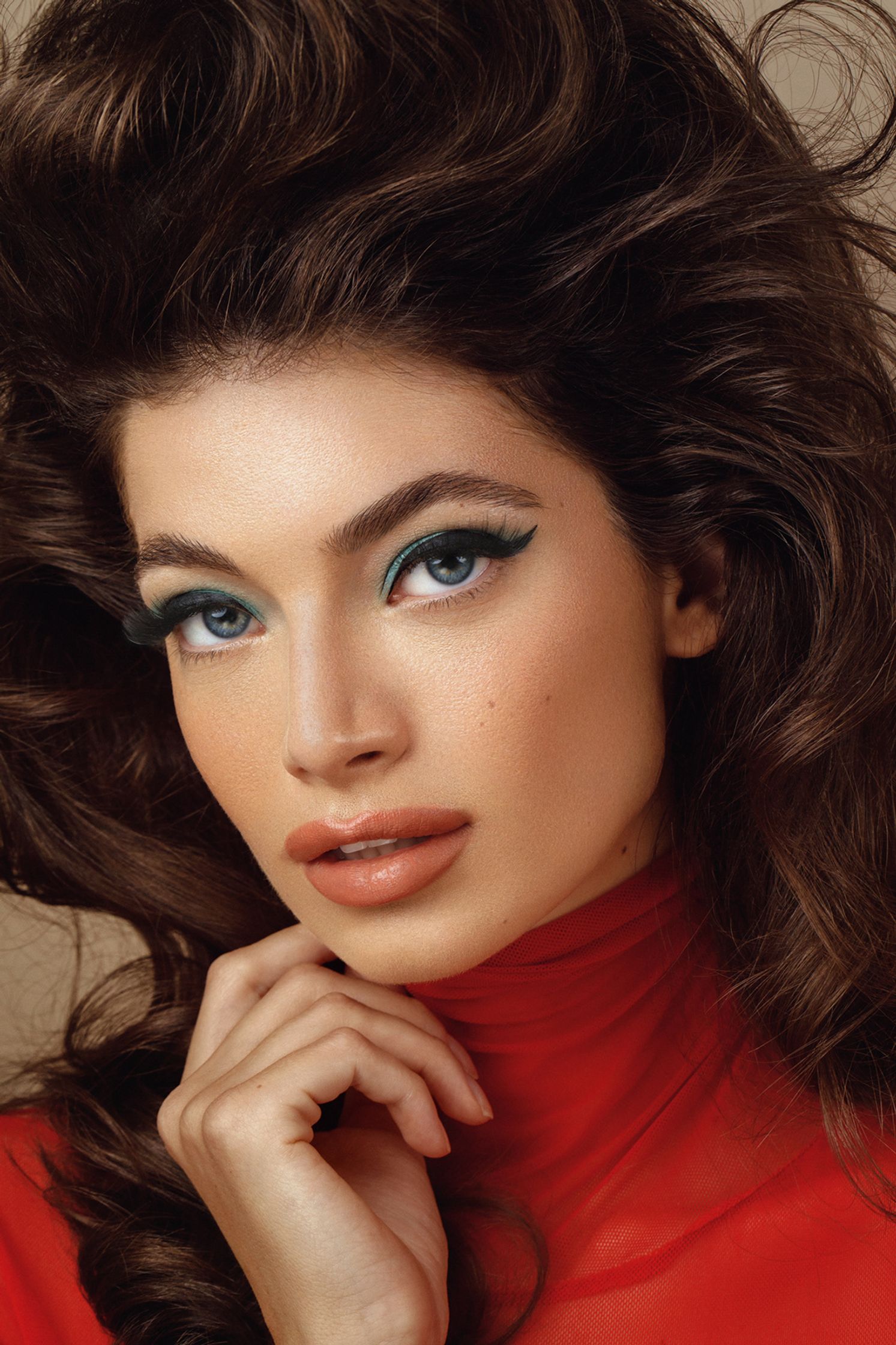 a woman with long brown hair posing for a photo