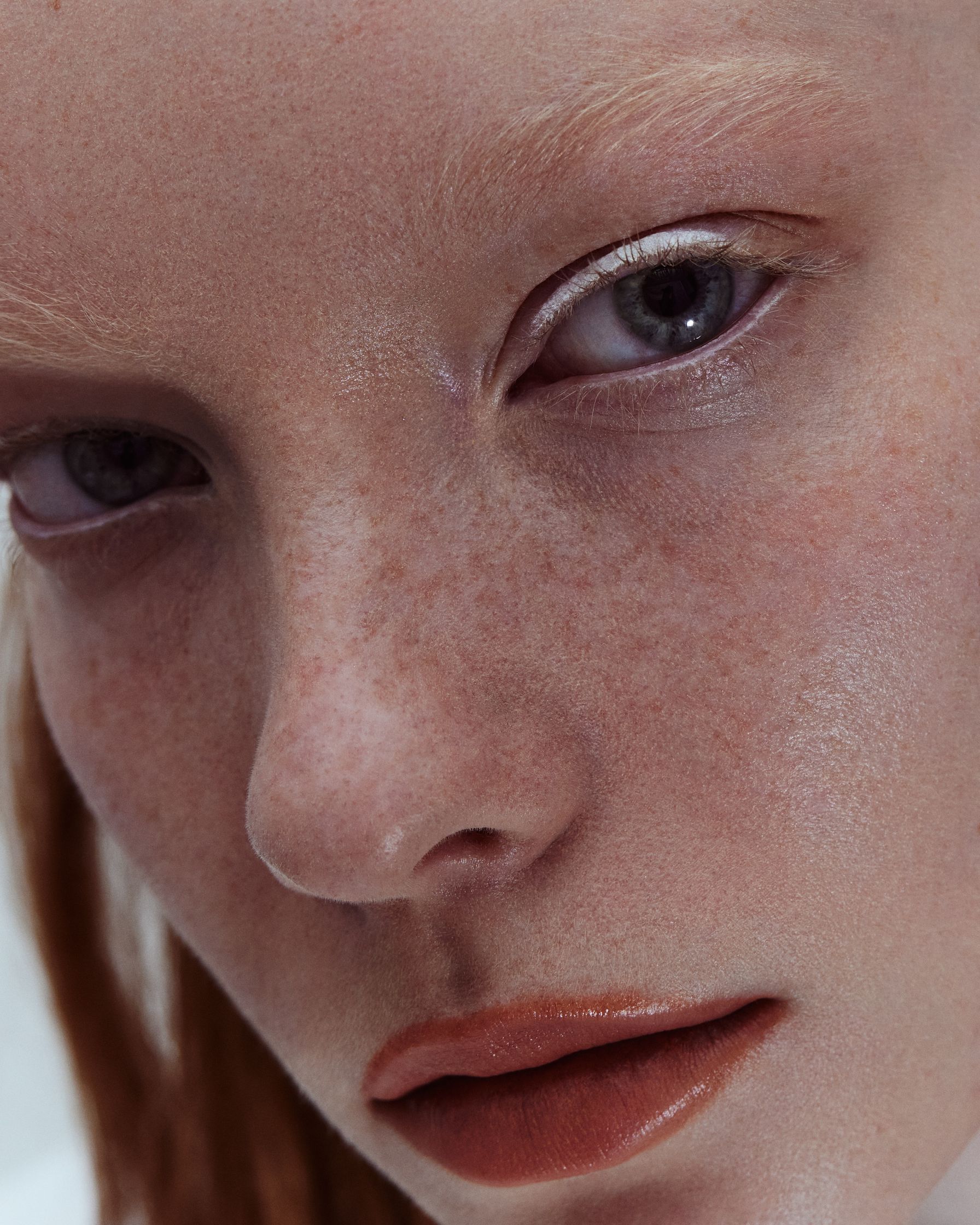 a close up of a woman with freckles on her face