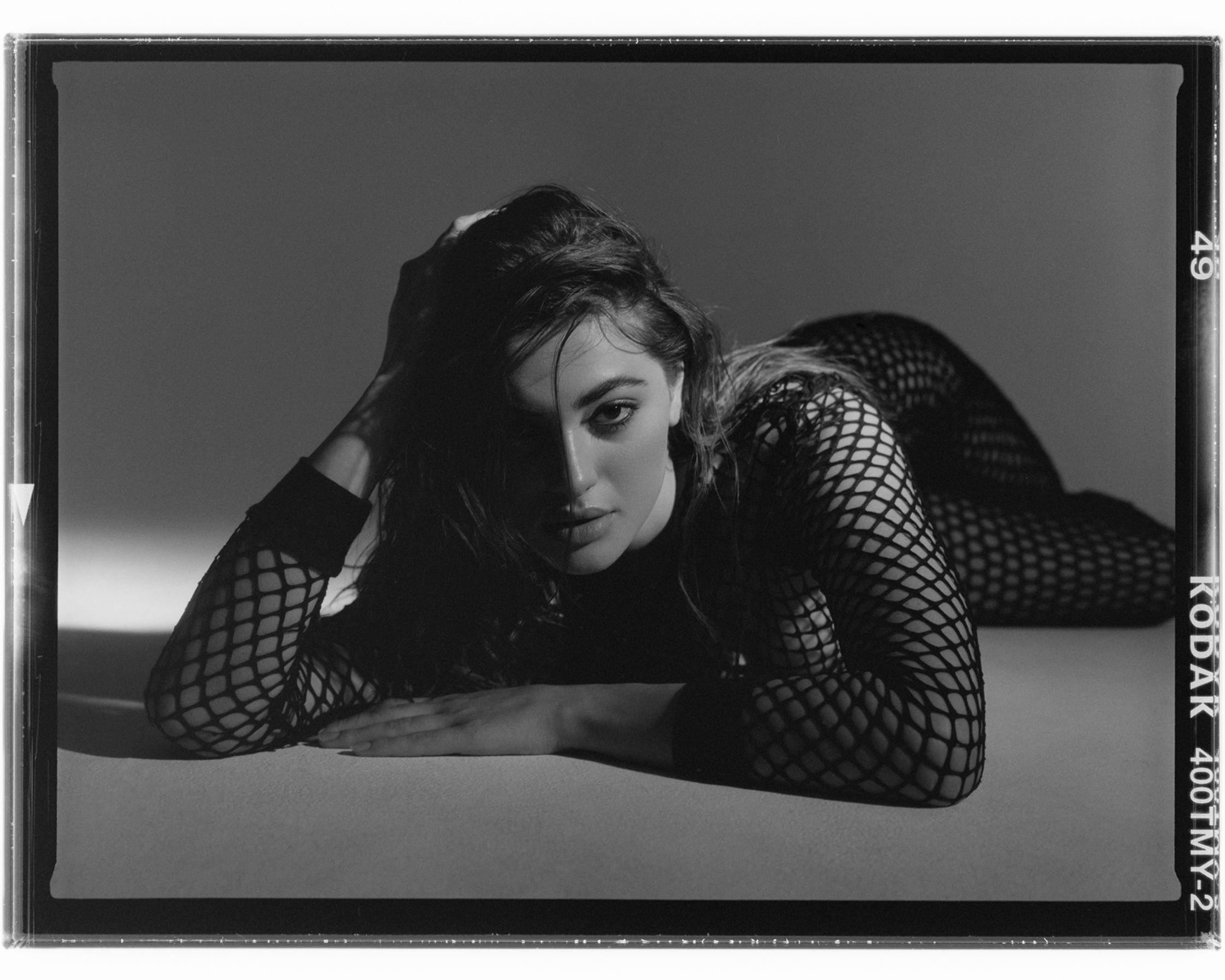 a black and white photograph of a woman in fishnets