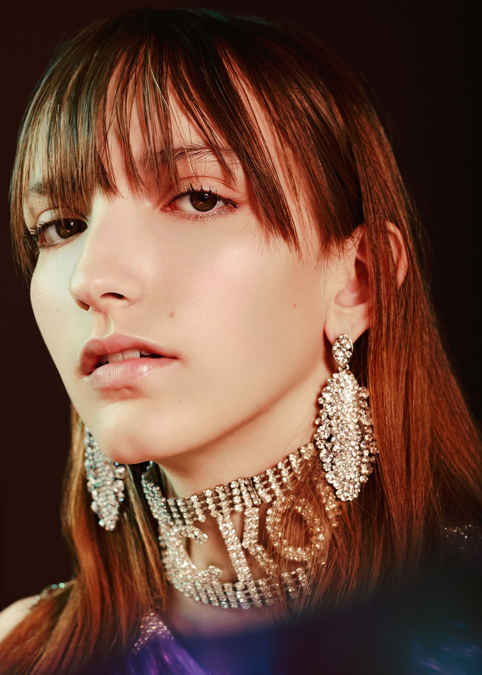 a woman wearing a necklace and earrings