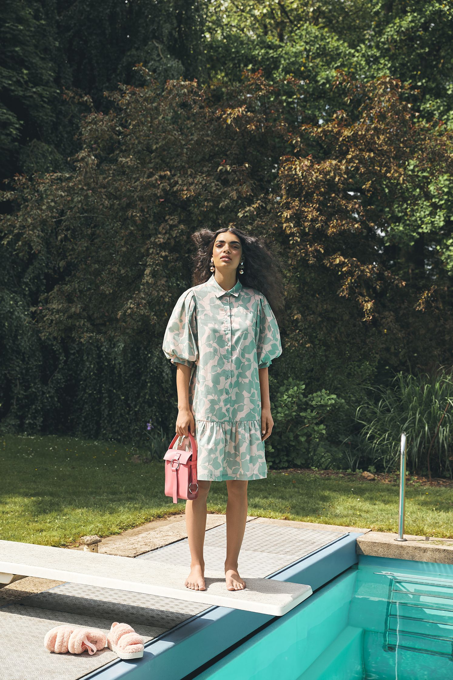 a woman standing on the edge of a pool