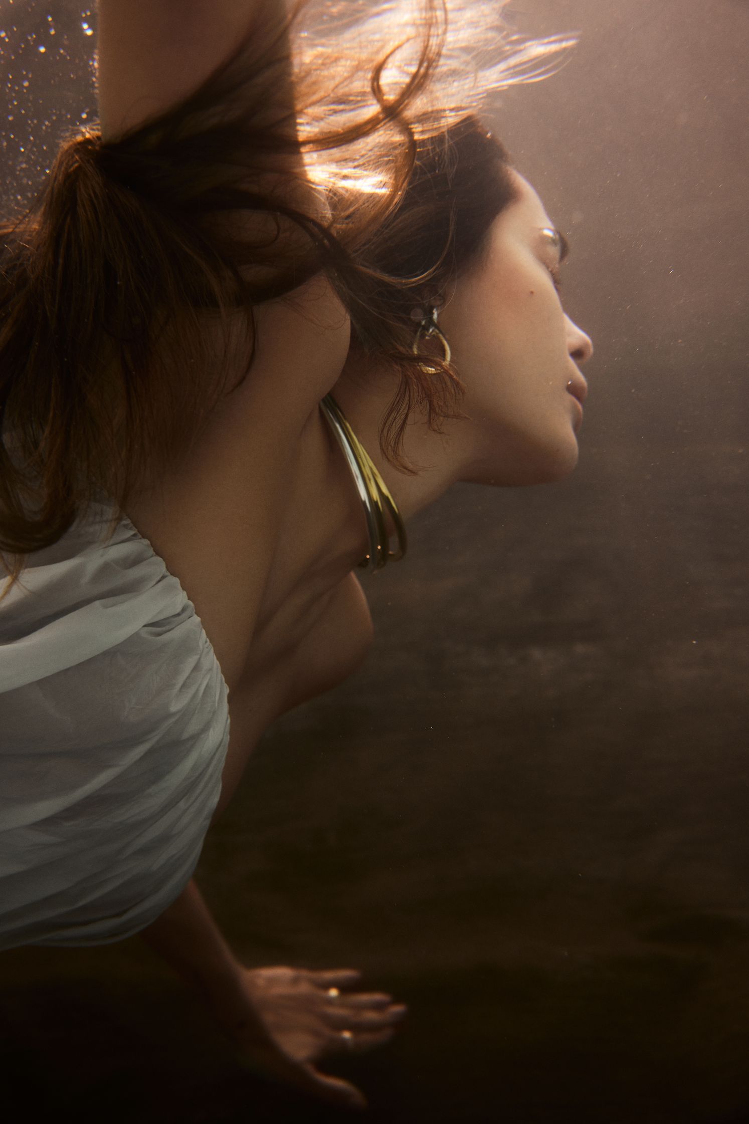 a woman in a white dress underwater