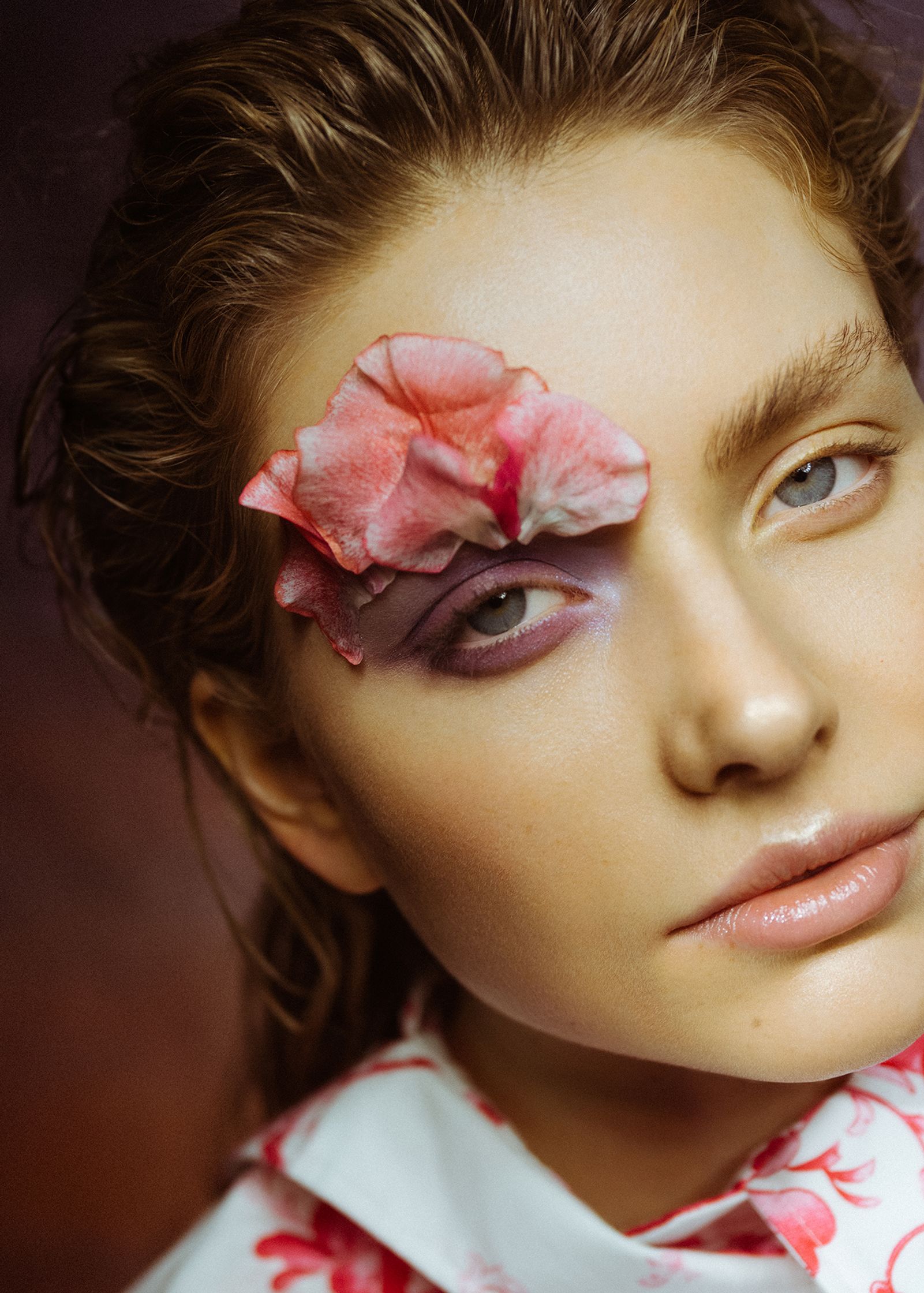 a woman with pink flowers on her face