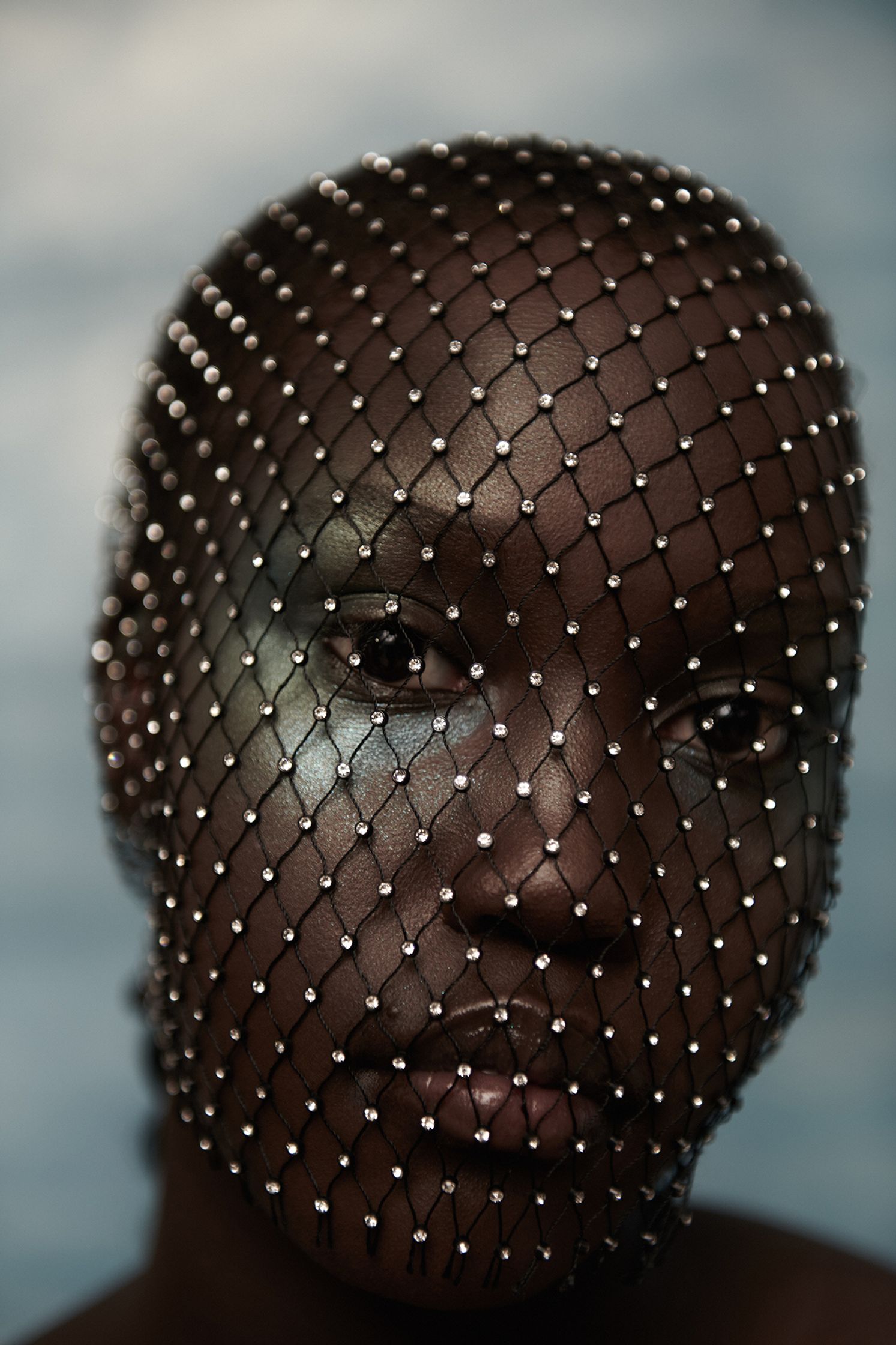 a black woman with a netted face