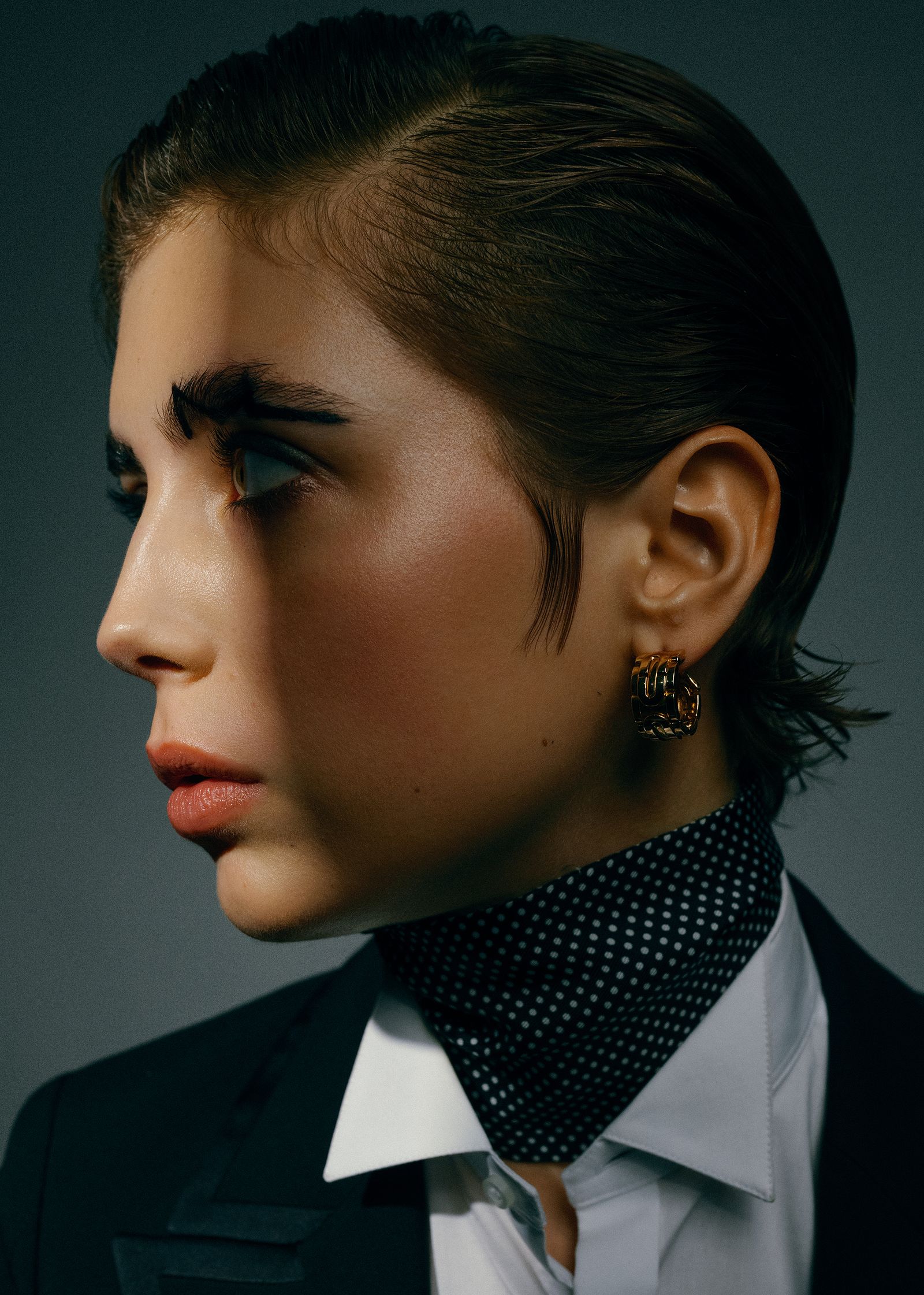 a woman in a tuxedo with a neck tie