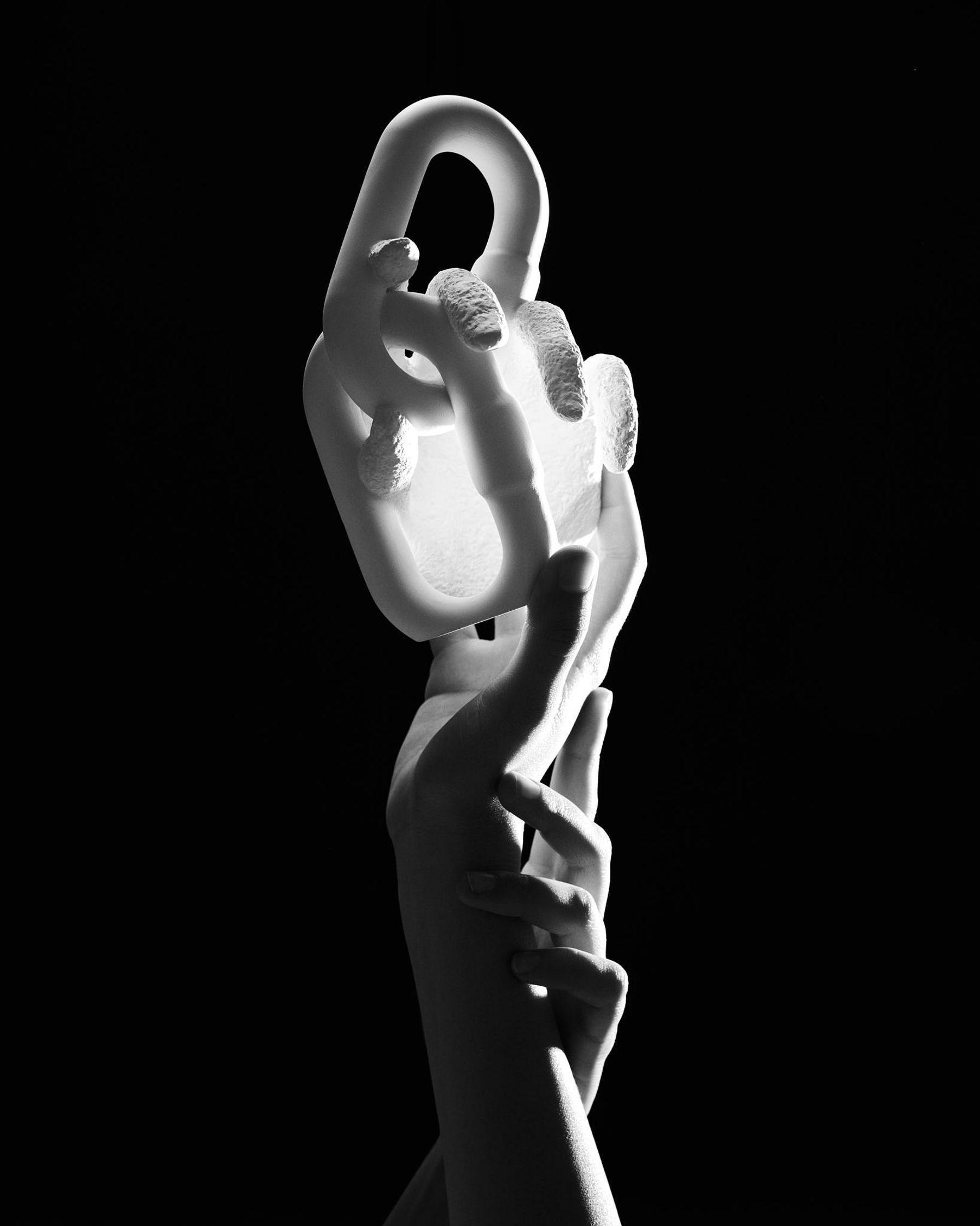 a black and white photo of a hand holding a light