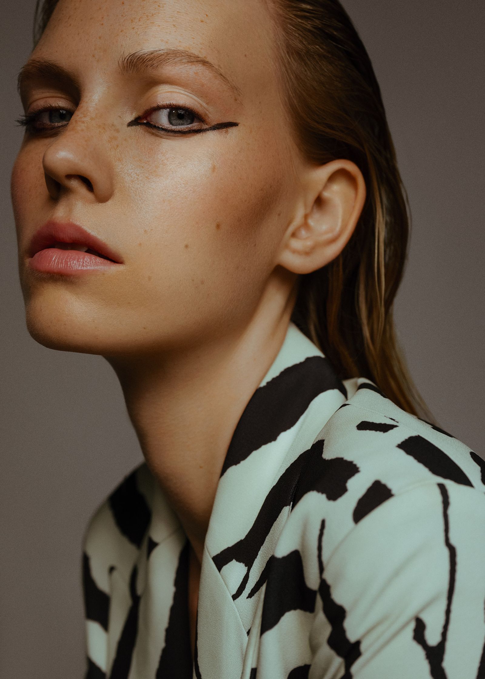 a woman in a zebra print jacket is posing for a photo