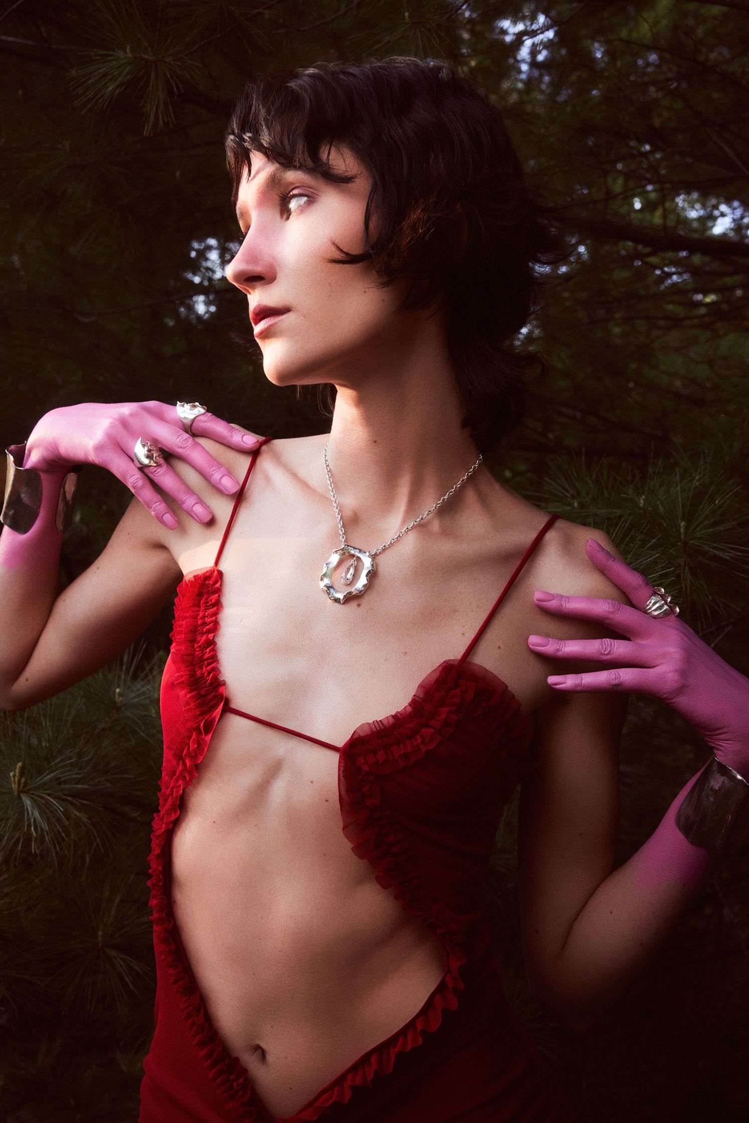 a woman wearing a red dress and pink gloves