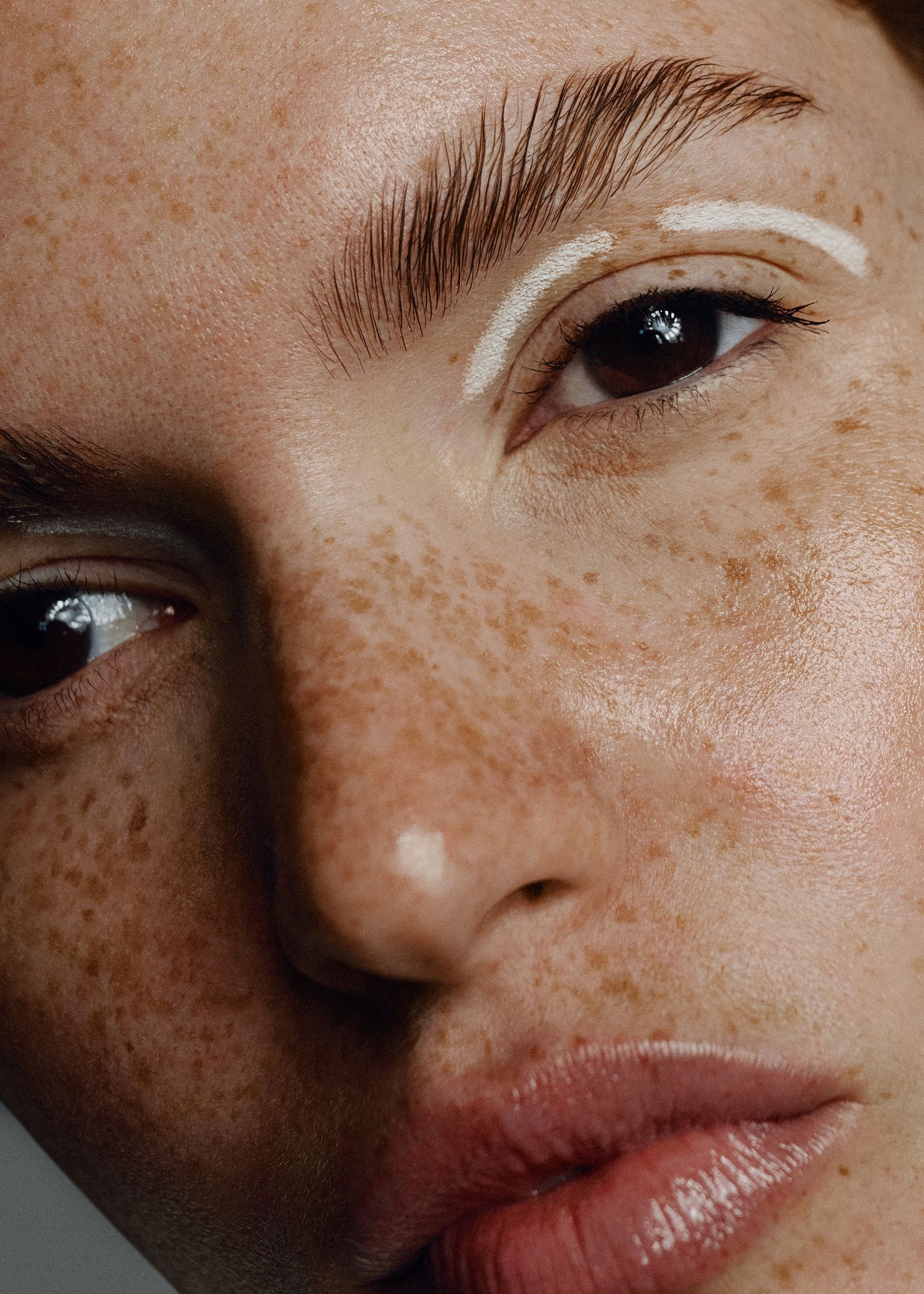 a close up of a woman with freckles on her face