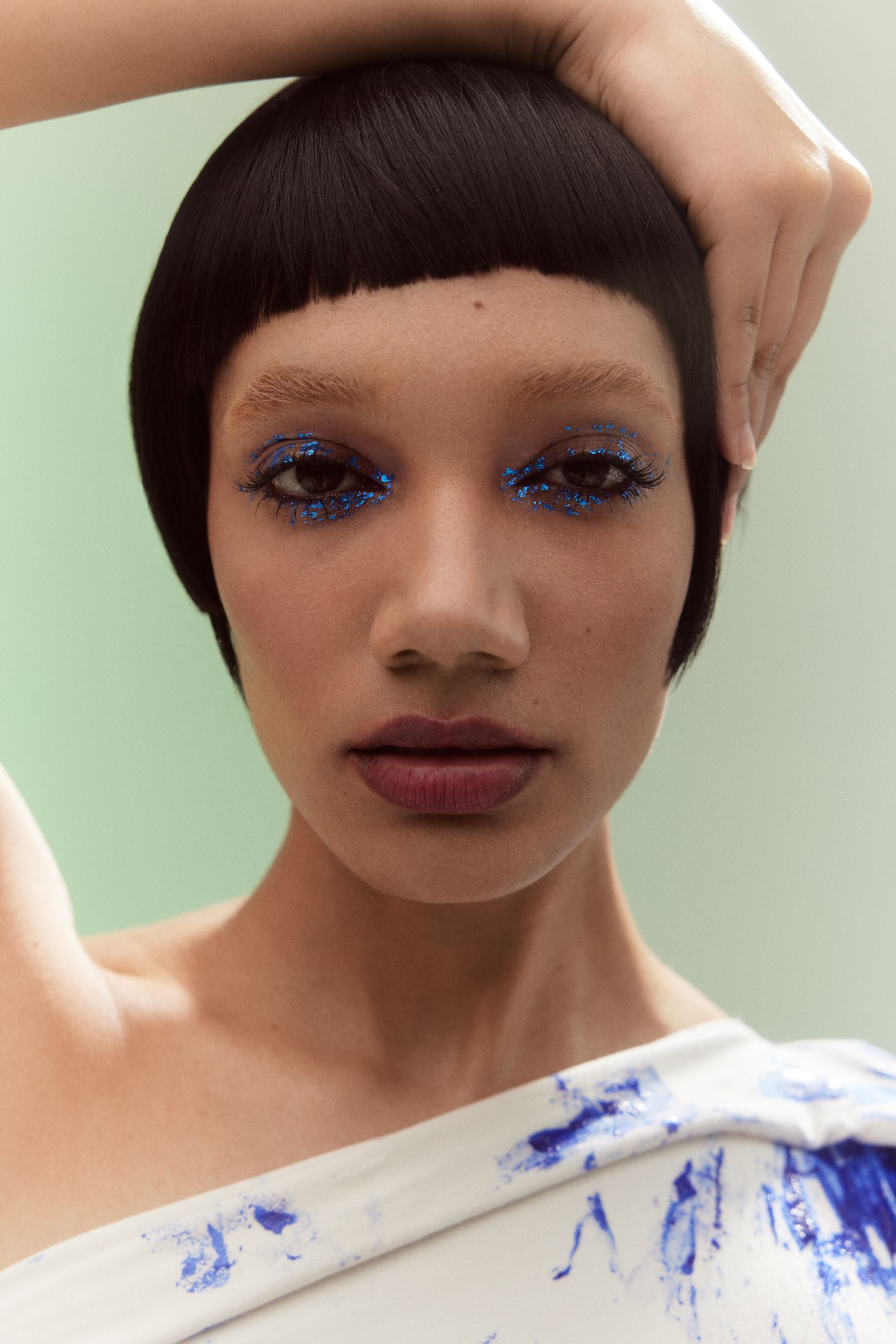 a woman with blue eyeshadow on her face