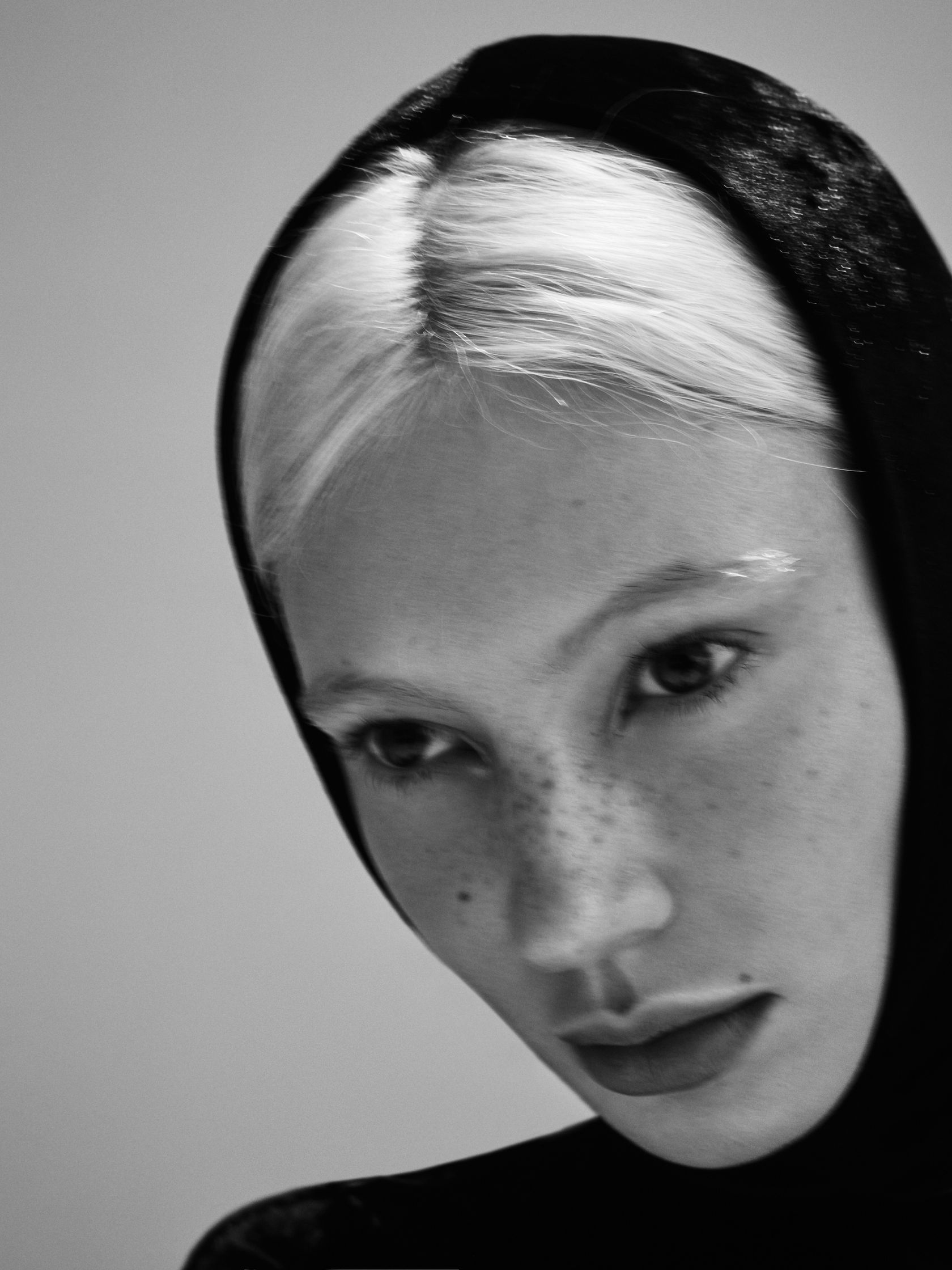 a black and white photo of a woman with white hair