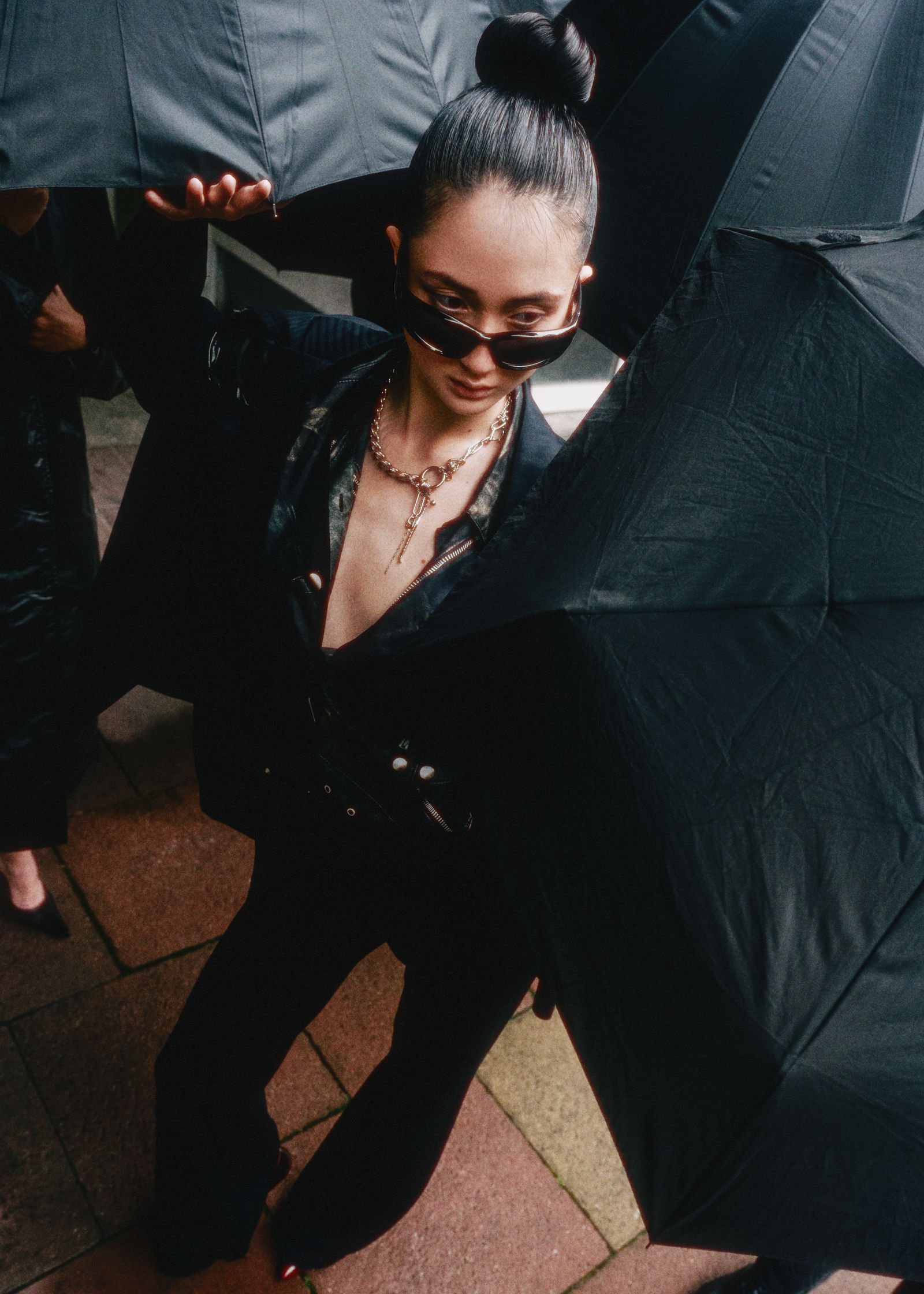 a woman holding a black umbrella