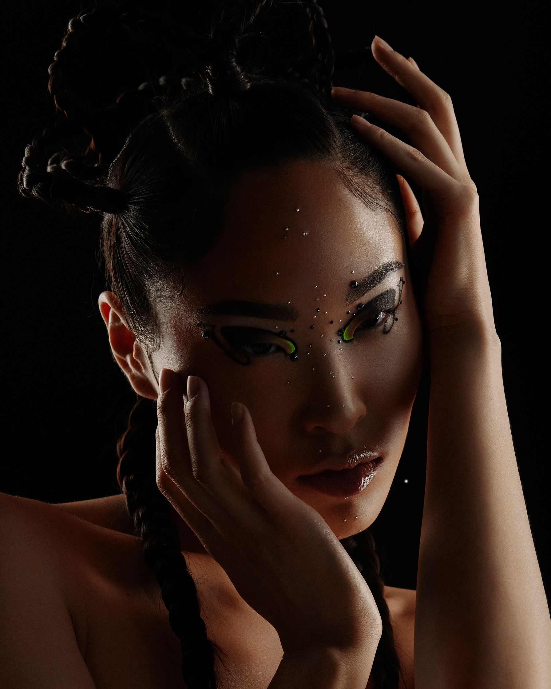 a woman with braided hair posing on a black background
