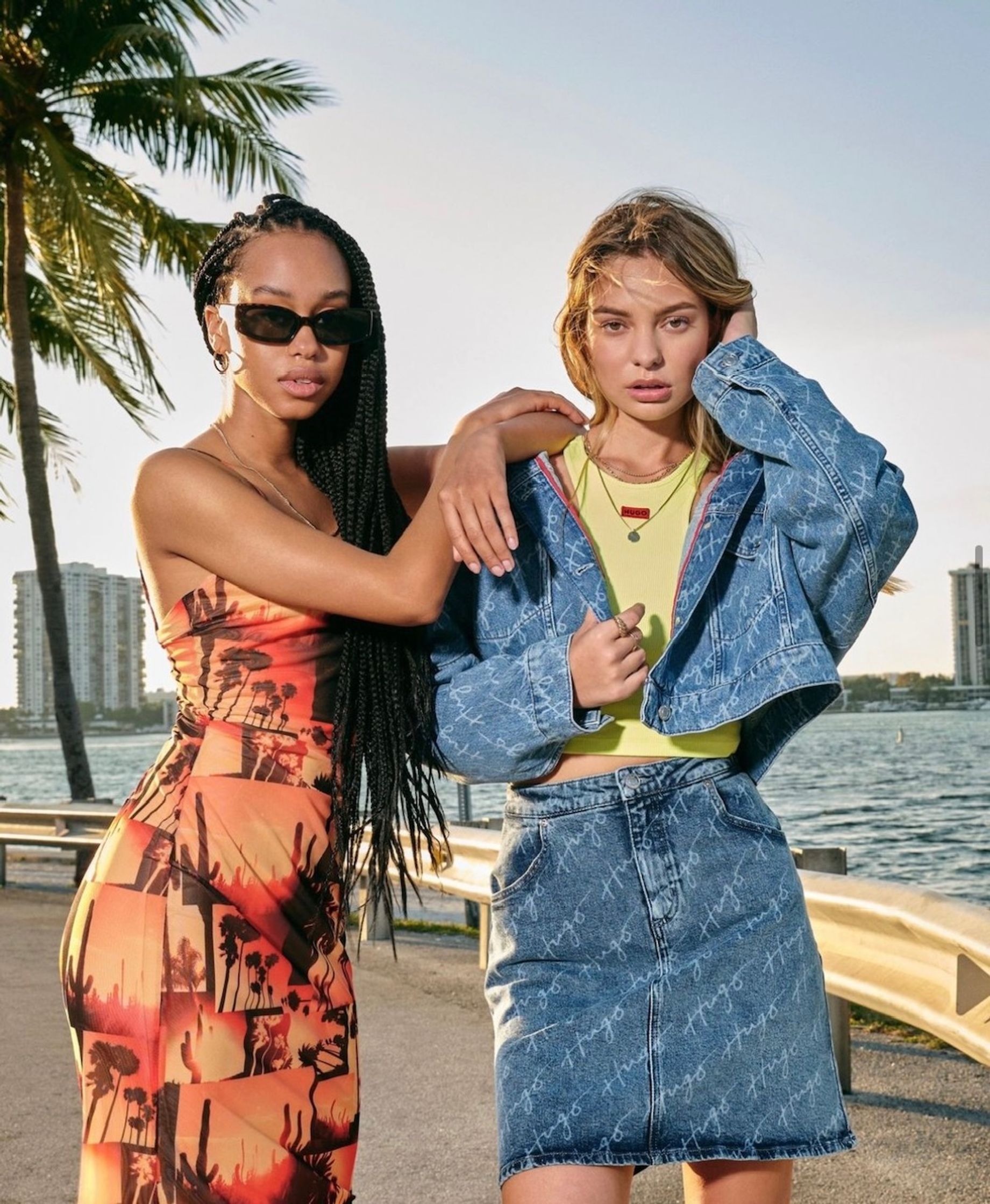 two women posing in front of a palm tree usc uk
