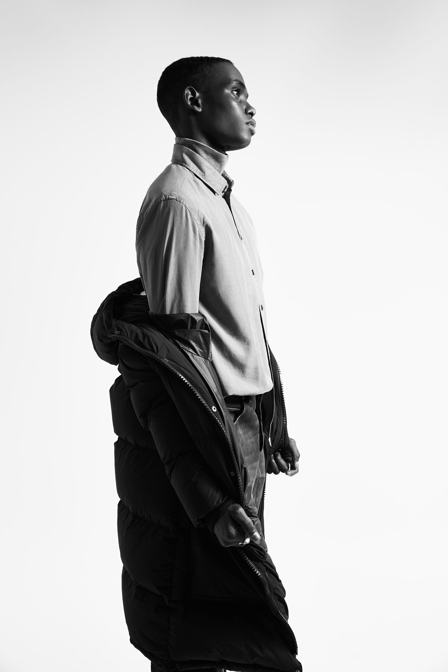 a black and white photo of a man in a jacket