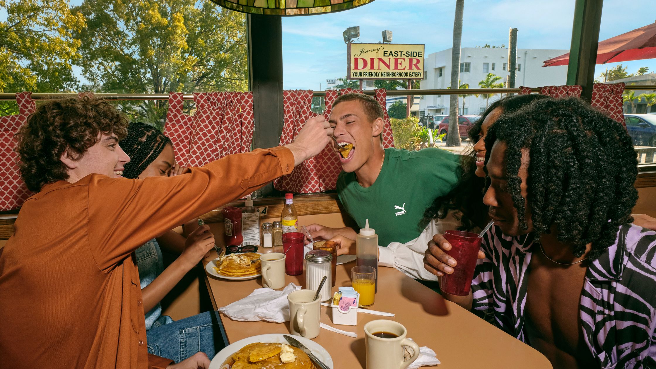 a group of people eating at a diner use uk