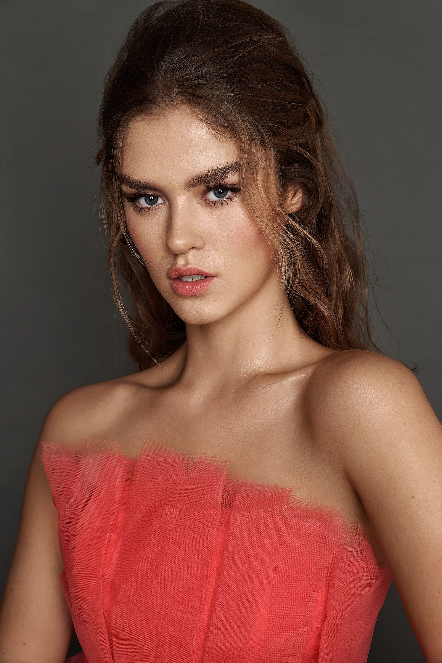 a young woman in a red dress posing for a photo