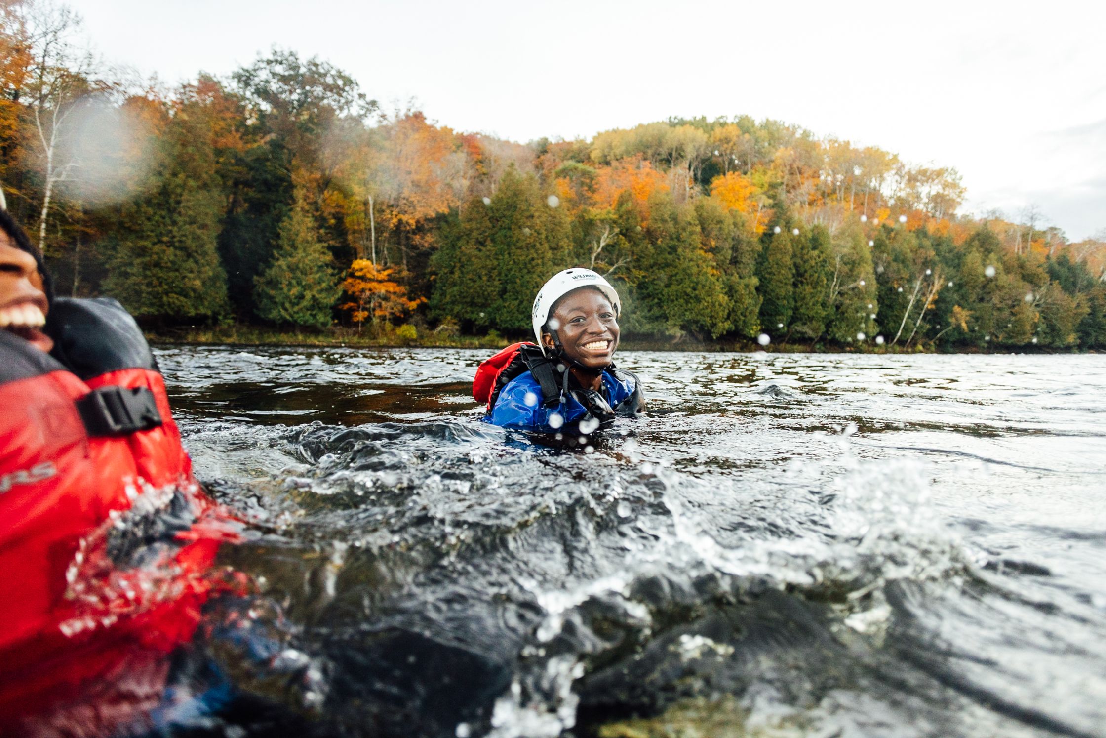 two people in life jackets in the water