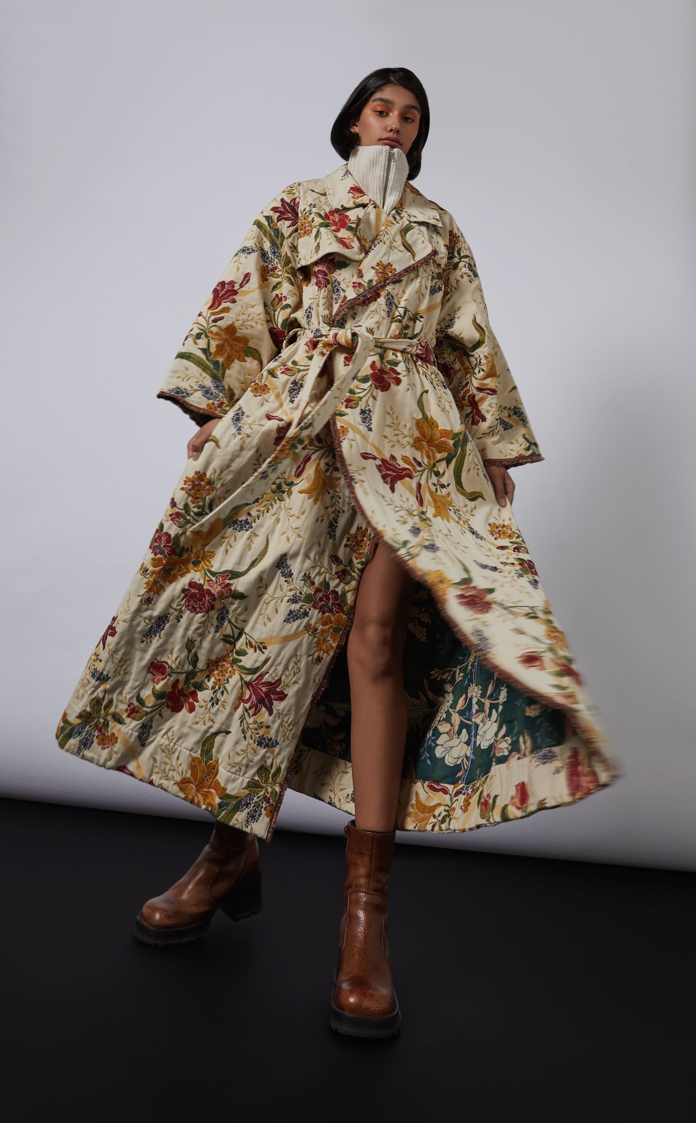 a woman wearing a floral printed coat and boots