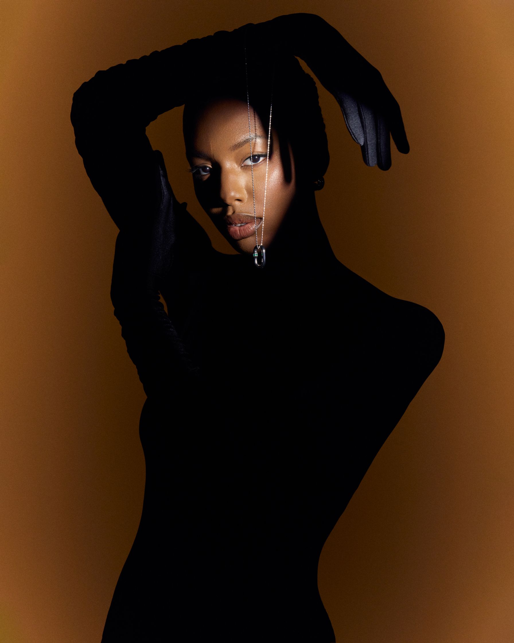 a black woman in a black dress posing with her hands on her hips