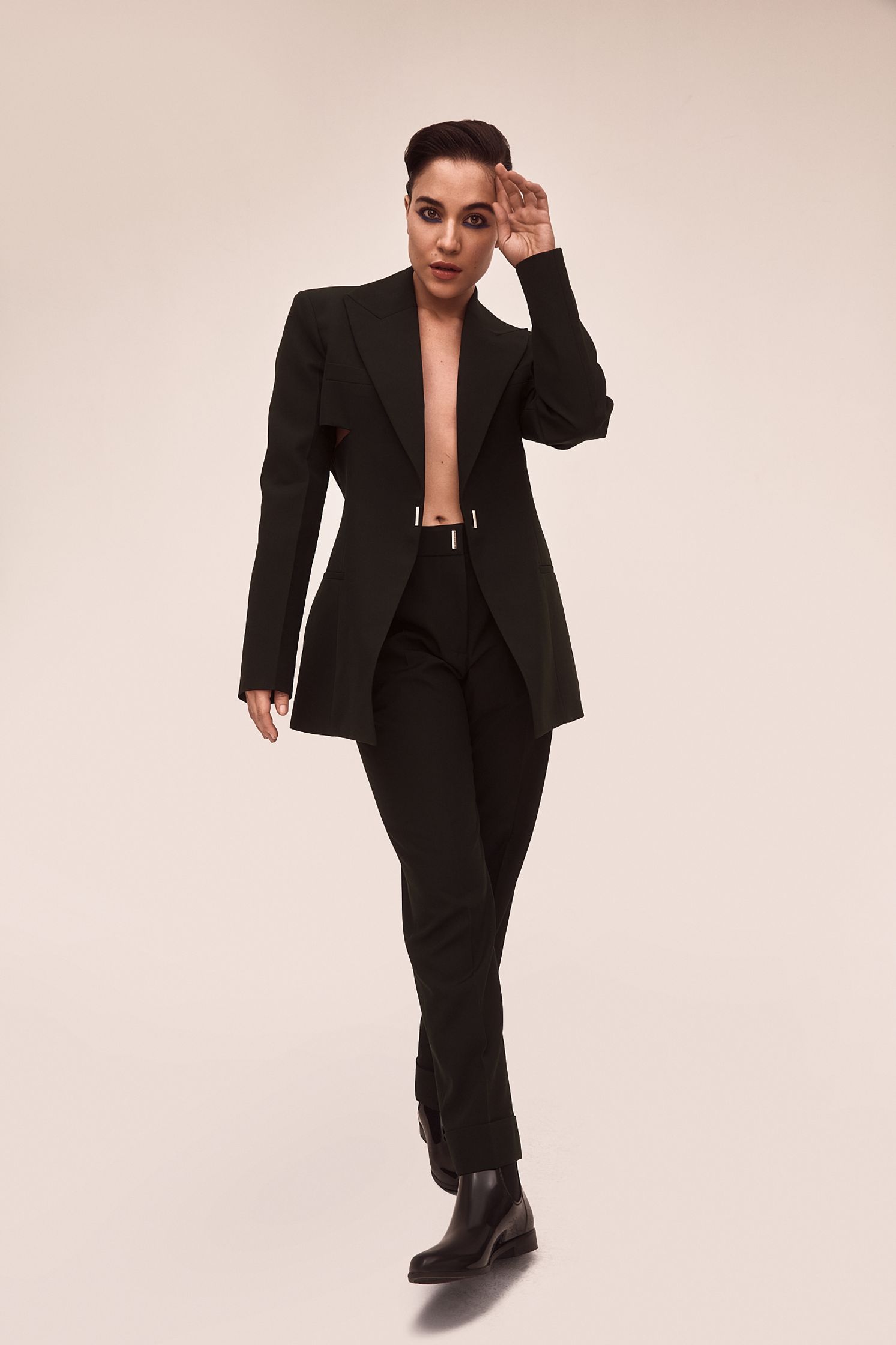 a woman in a black suit posing