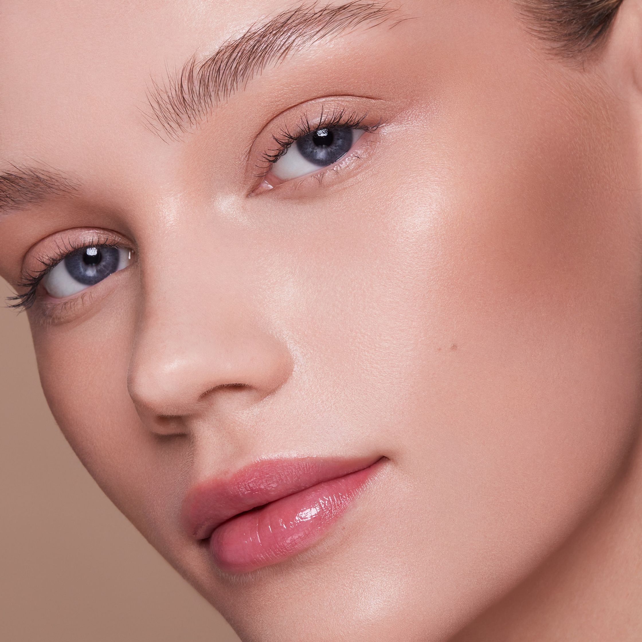 a close up of a woman's face with blue eyes