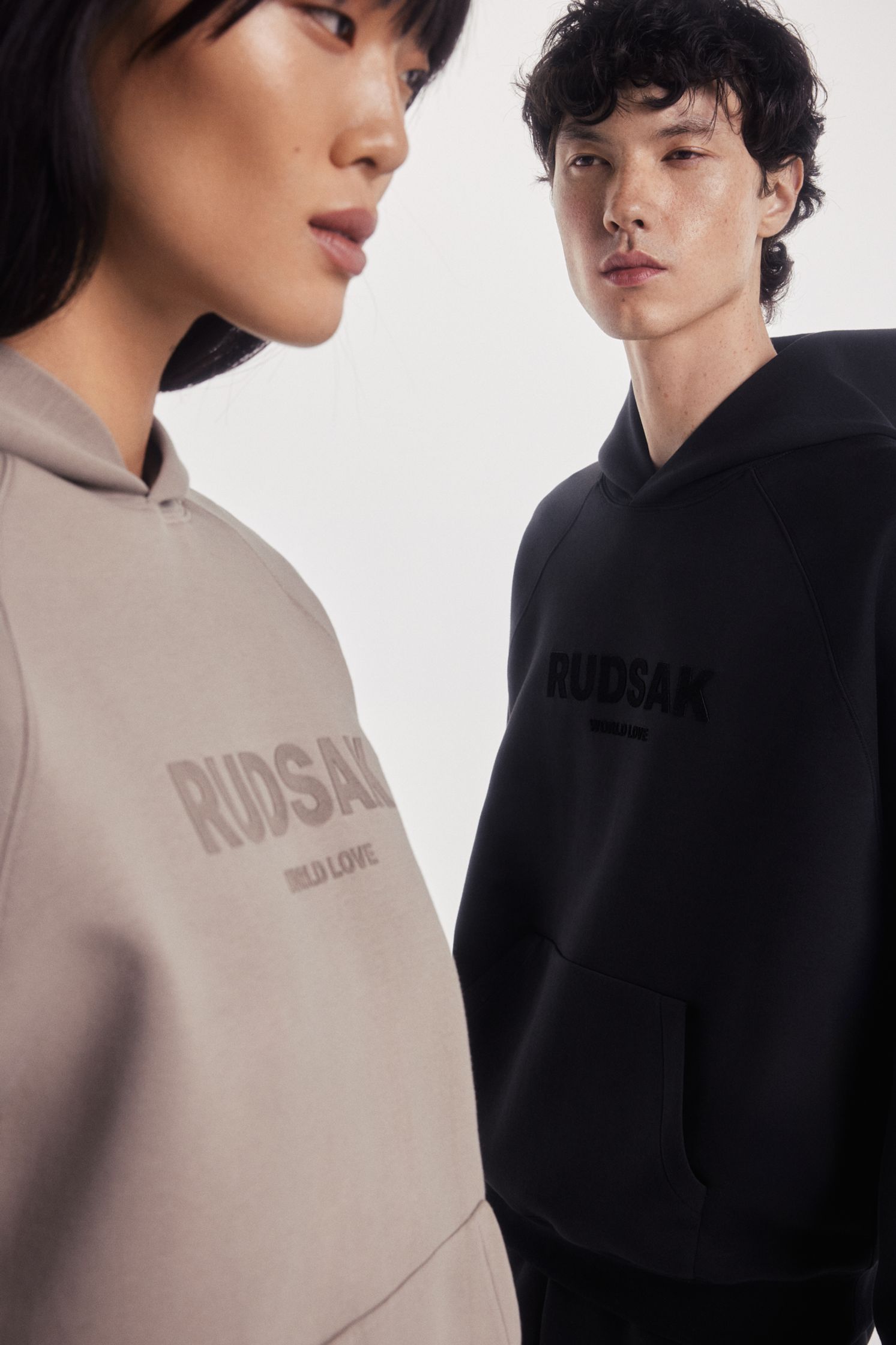 a man and a woman wearing a hoodie with the word rossak on it