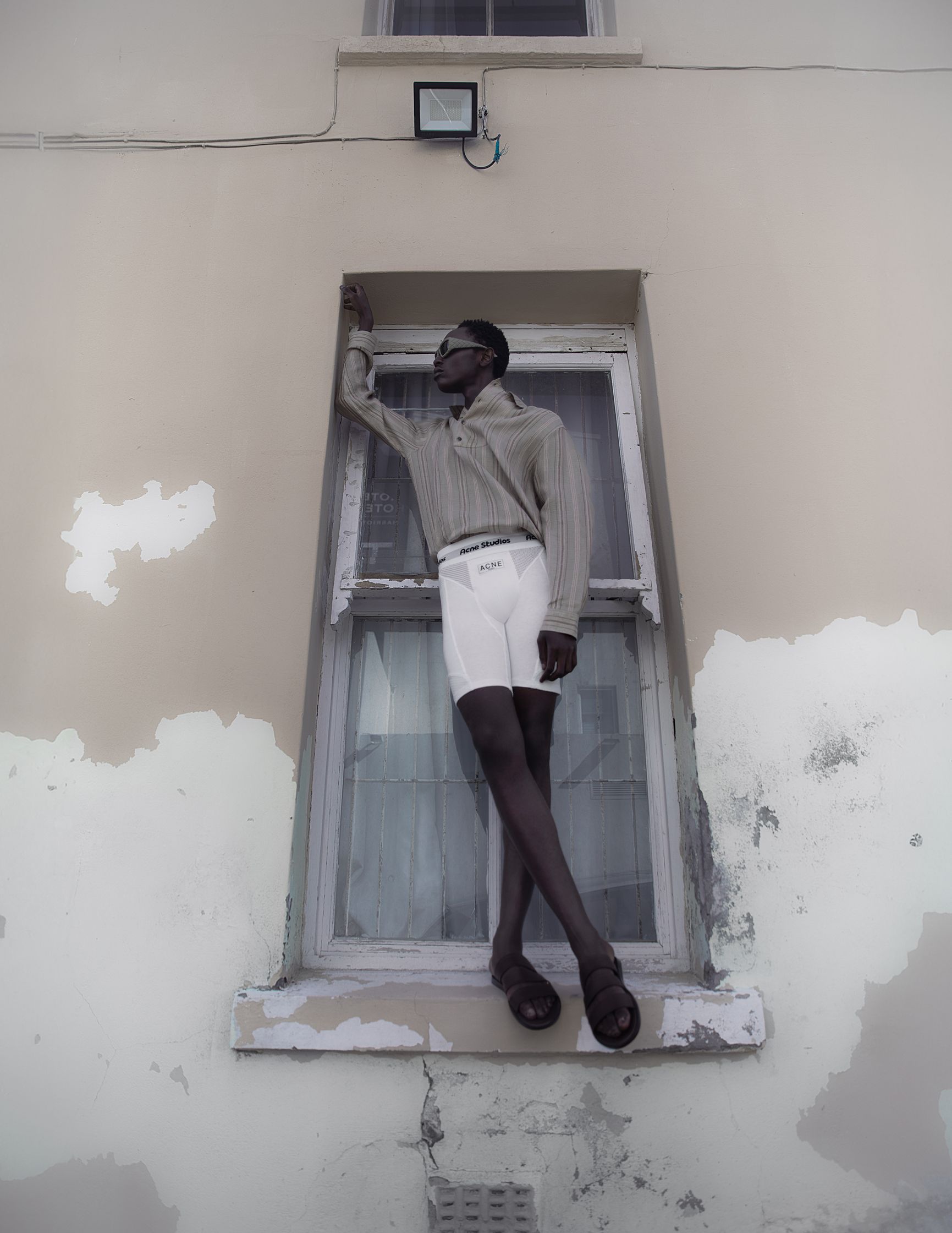a man is standing on a window ledge