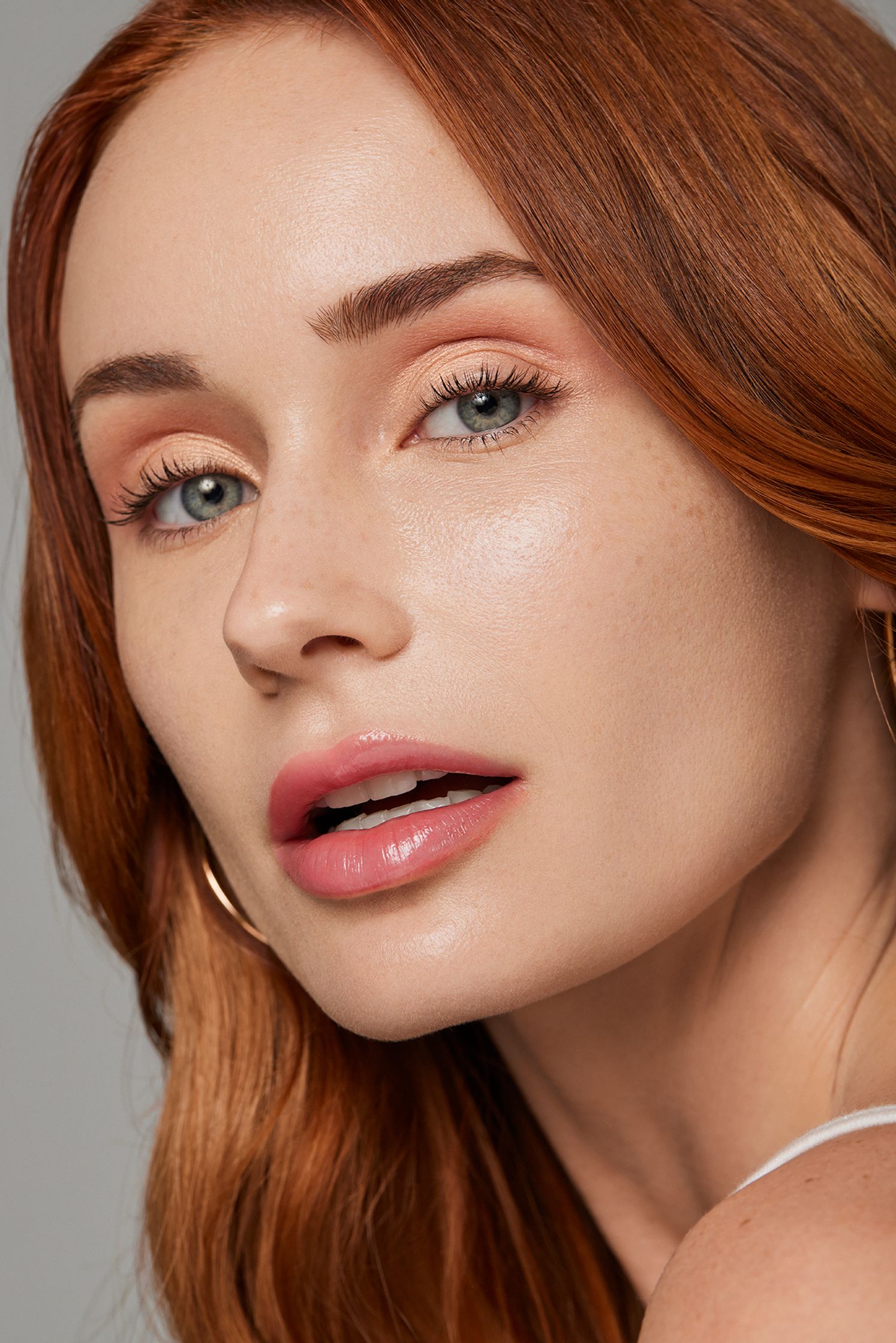 a woman with red hair is posing for a photo