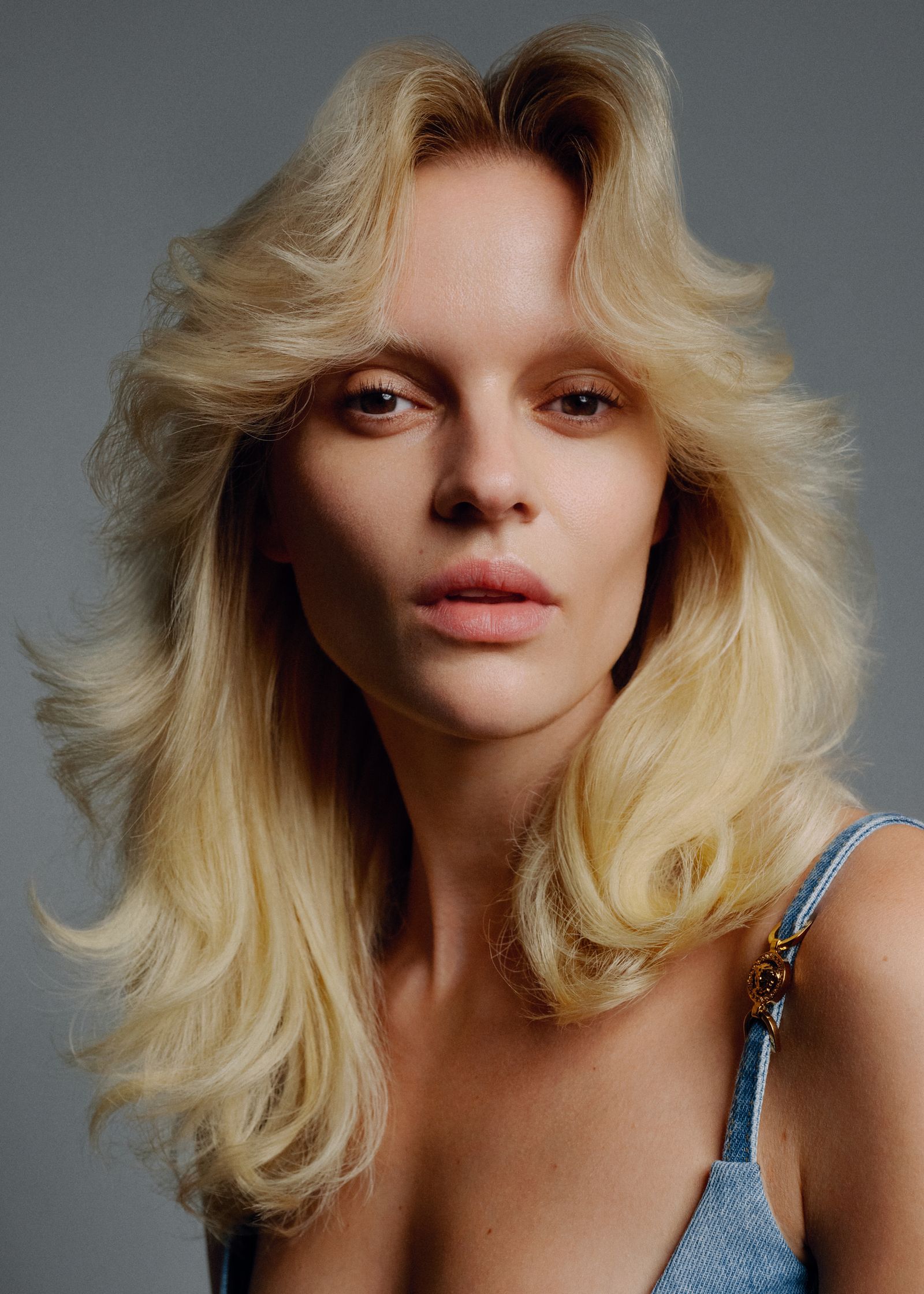a woman with long blonde hair posing for a magazine