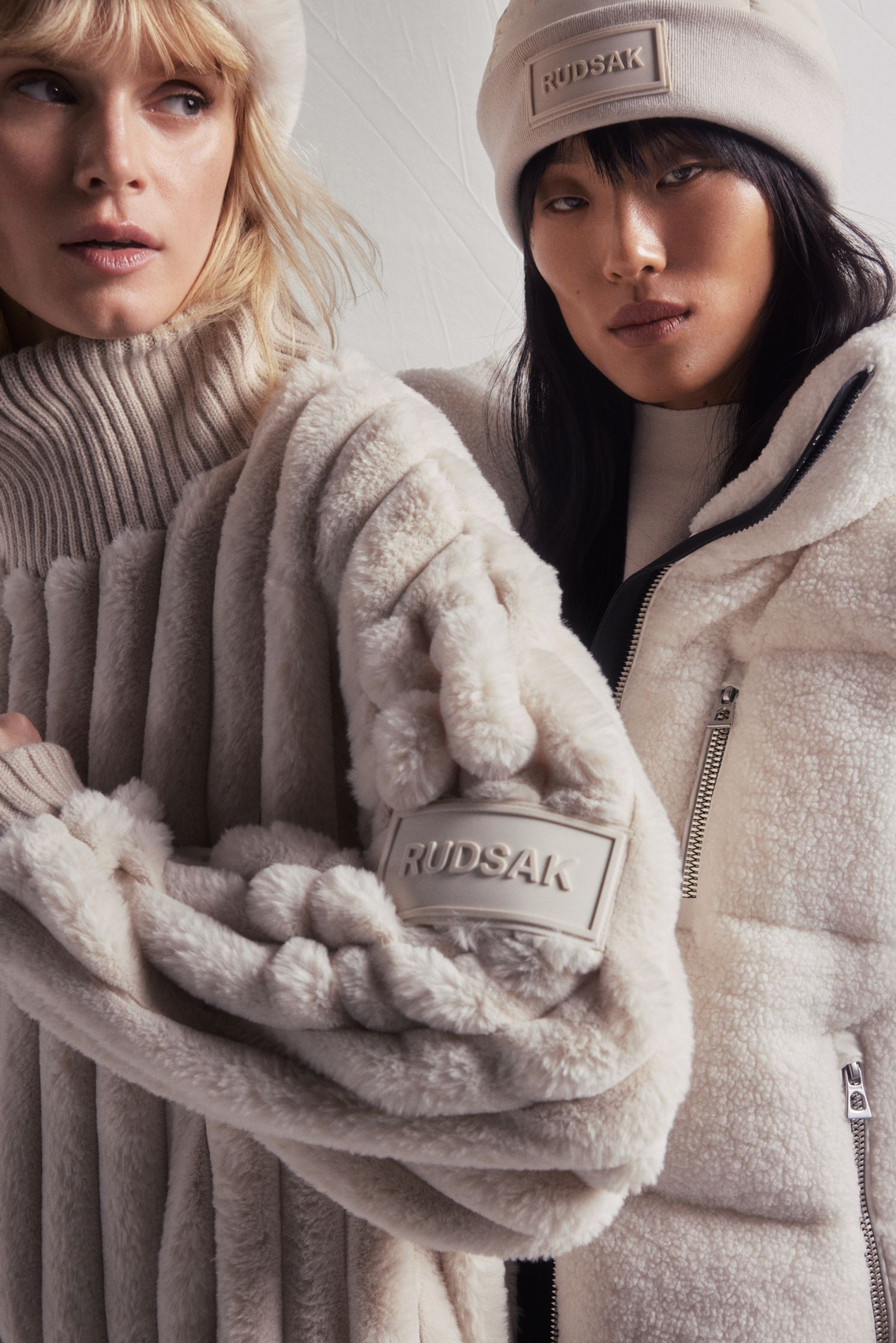 two women wearing beige fur coats and hats