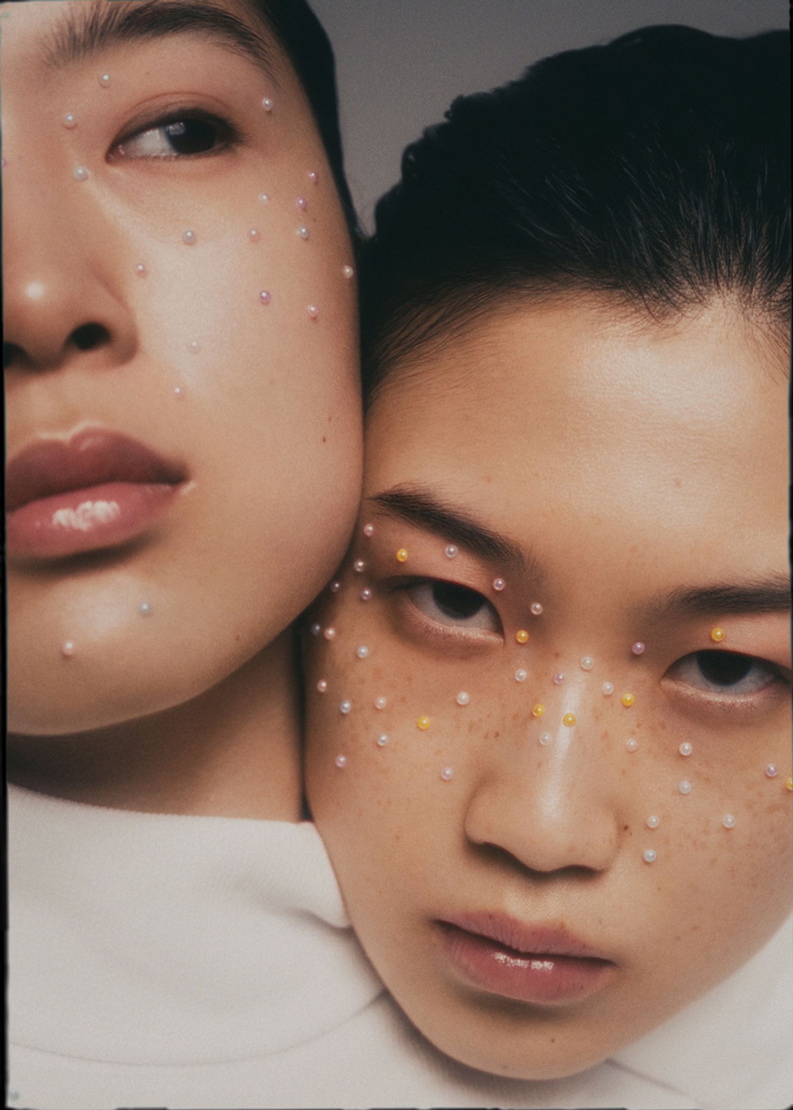 two asian women with freckles on their faces