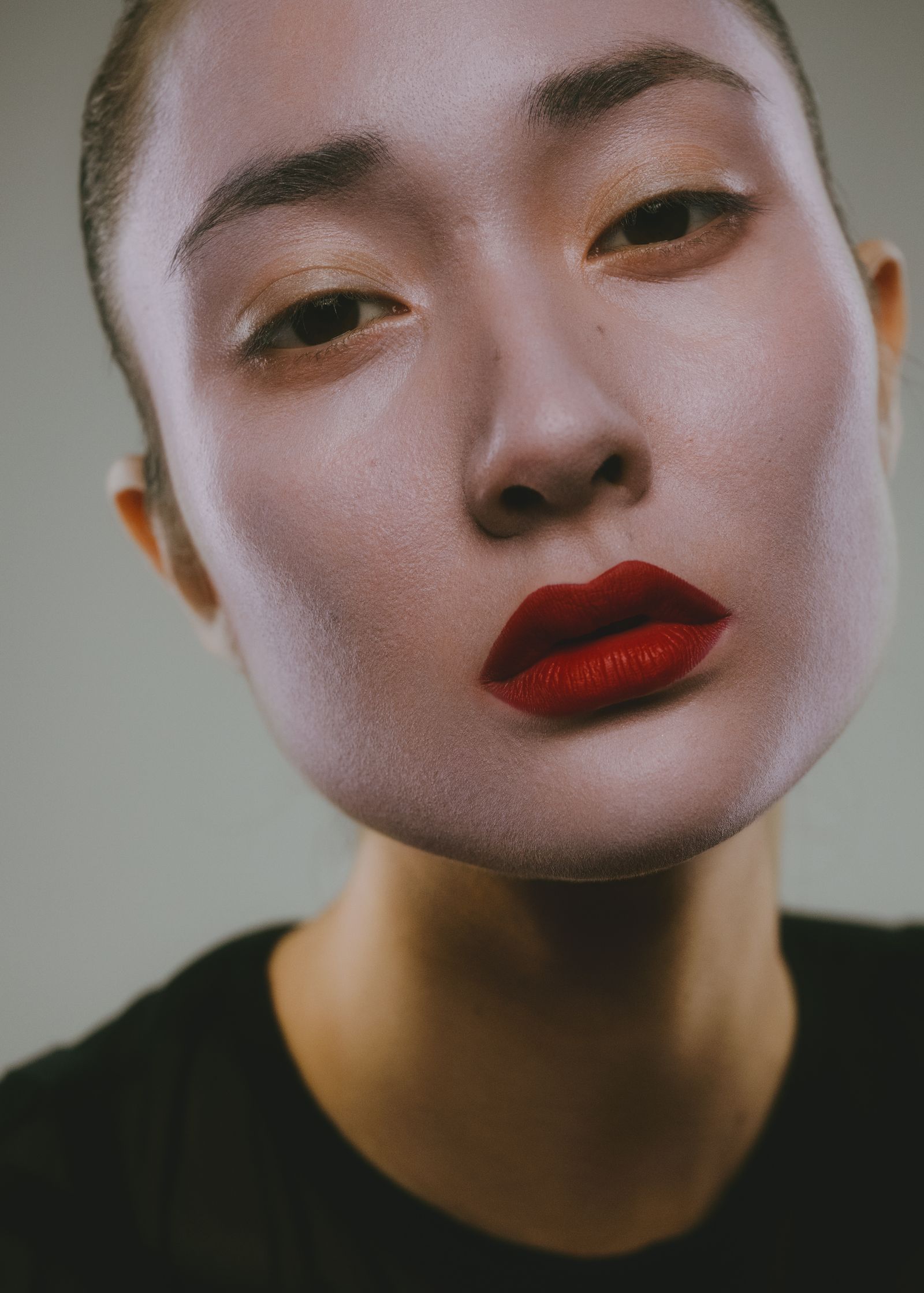 a woman with red lipstick and a black shirt