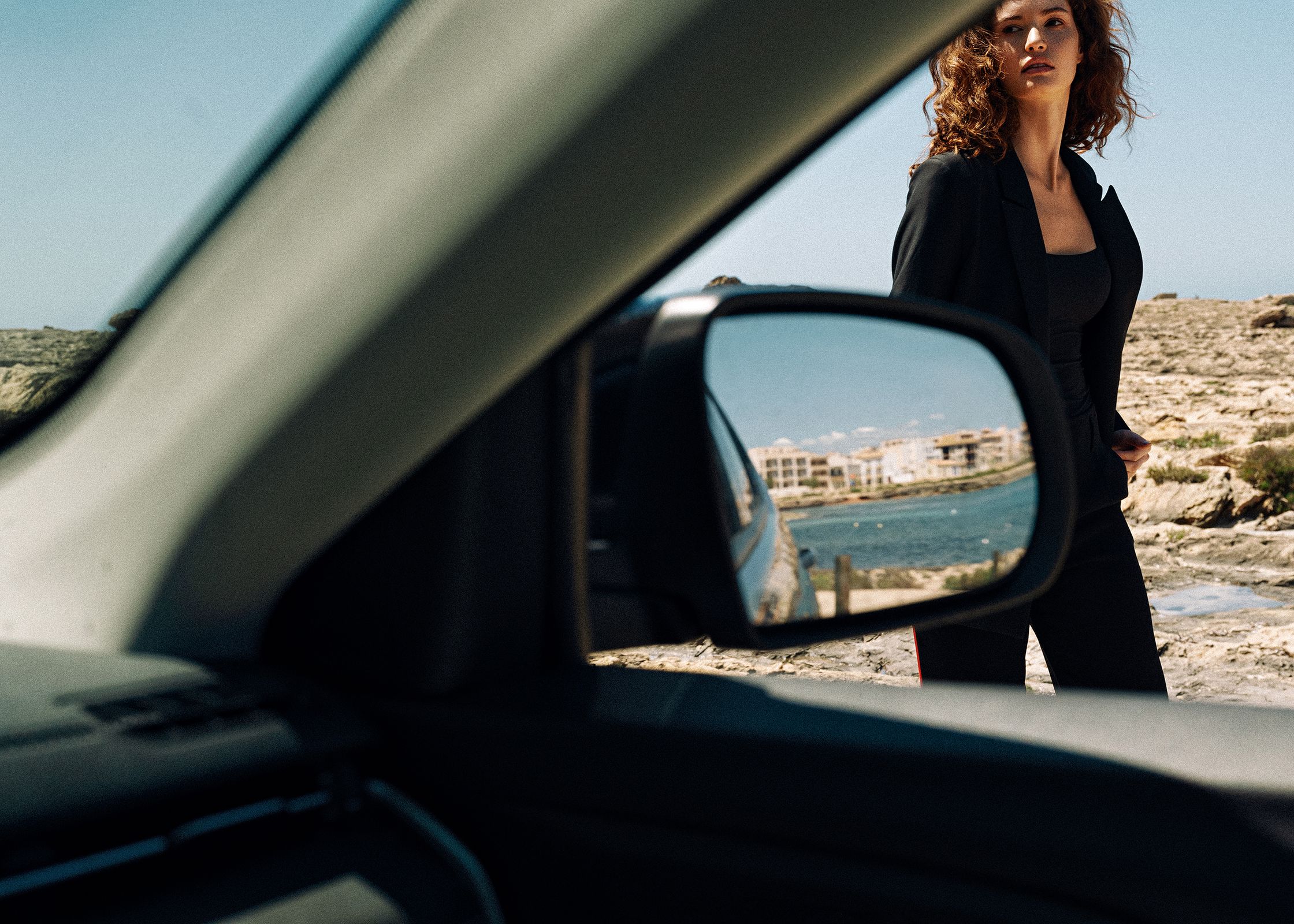 a woman standing in front of a car