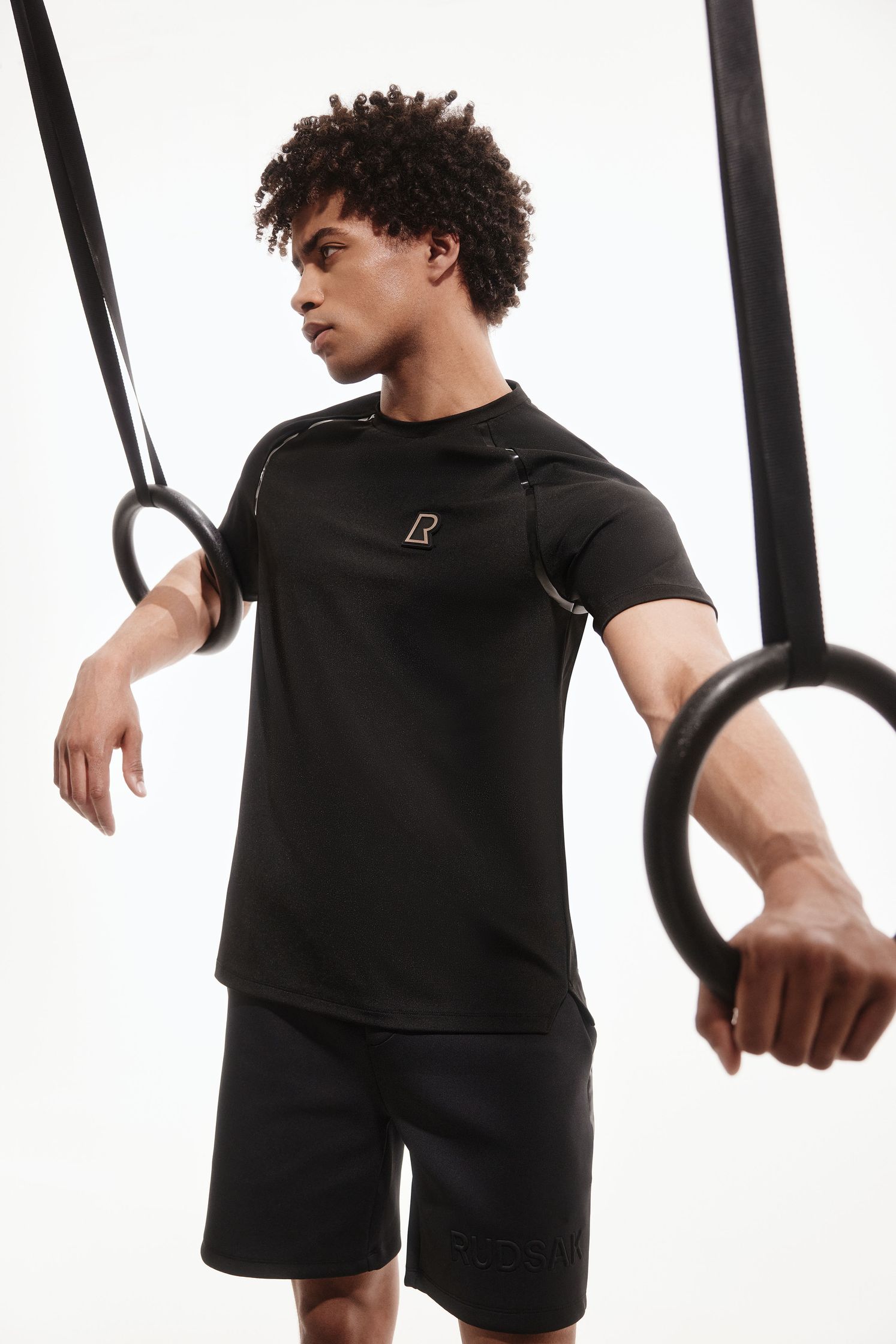 a man wearing a black t - shirt and a pair of rings