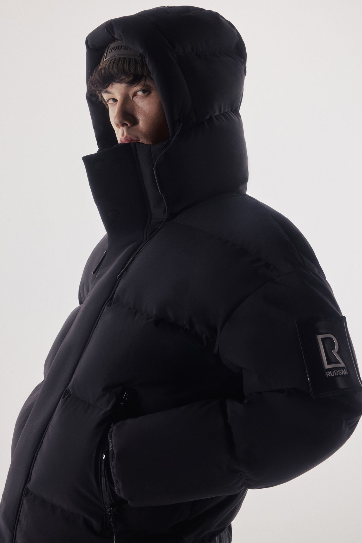 a man wearing a black puffer jacket