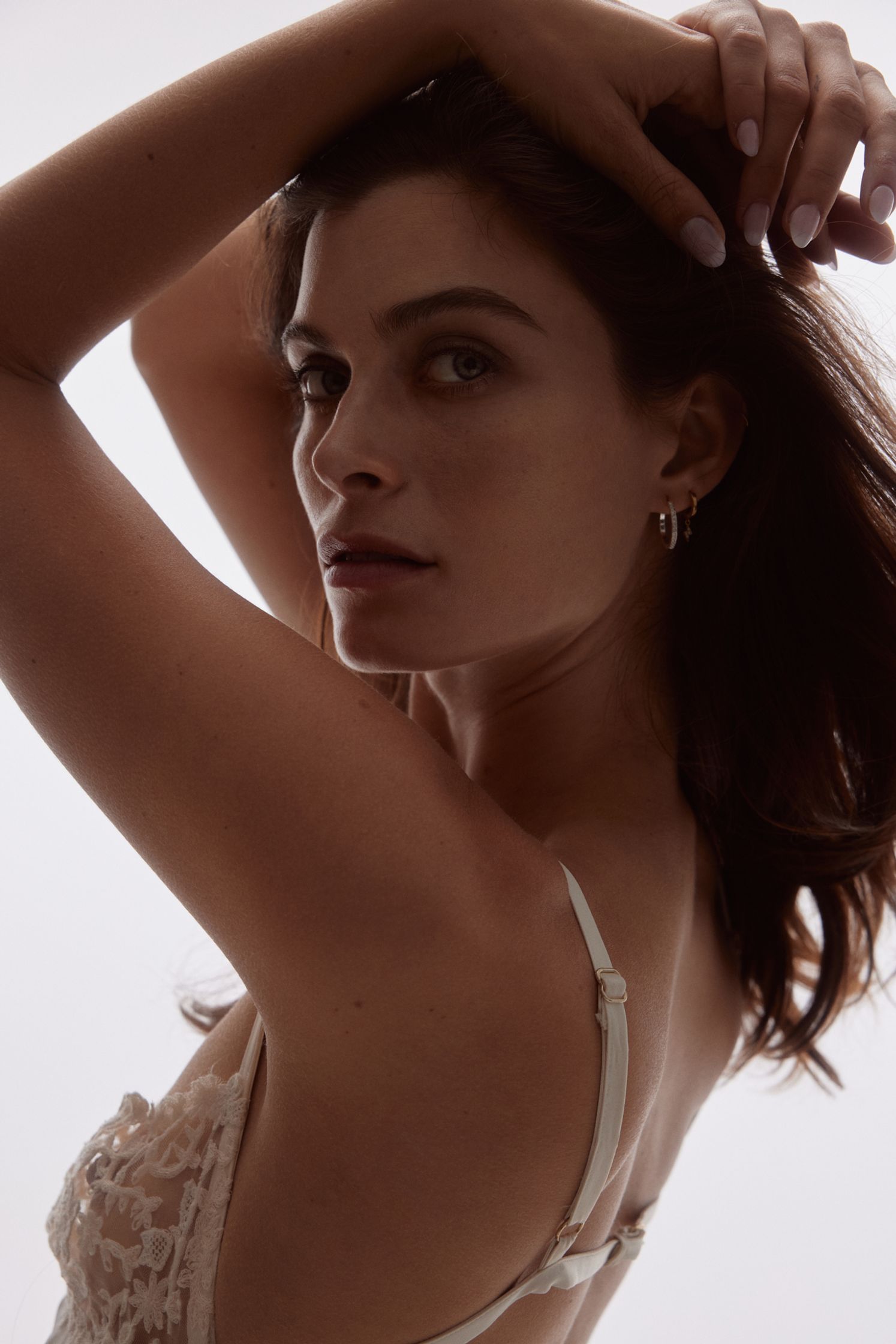 a woman is posing in a lingerier