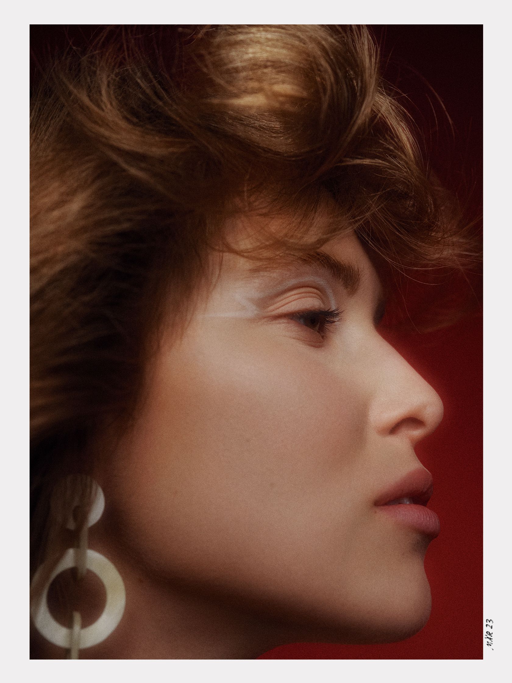 an image of a woman with a large earring